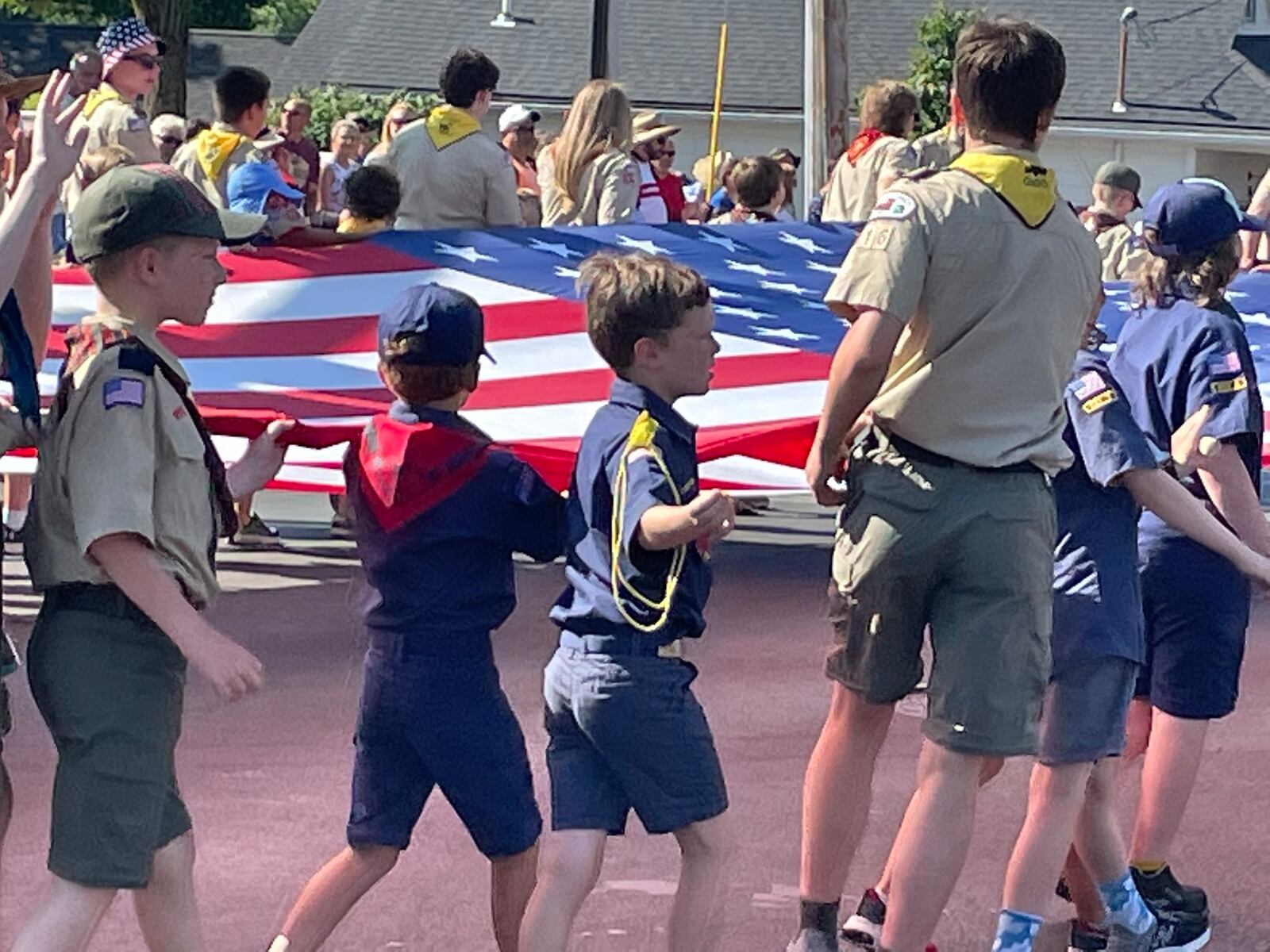 Scouts in the Americana Festival parade carried a large American flag Monday morning along the route, which this year included a turn south on Ohio 48. NICK BLIZZARD/STAFF