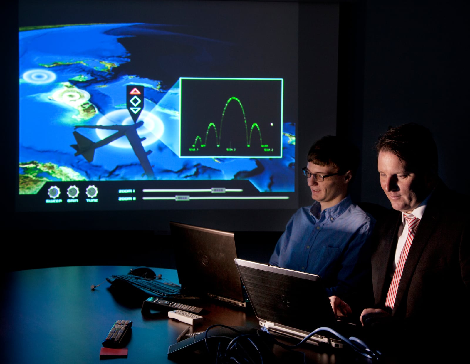 In this 2013 file photo, Aptima computer programmer Charlie Dickens, left, and director of Dayton operations Ronald Storm work on a new training program they plan to offer to the Department of Defense. TY GREENLEES/STAFF