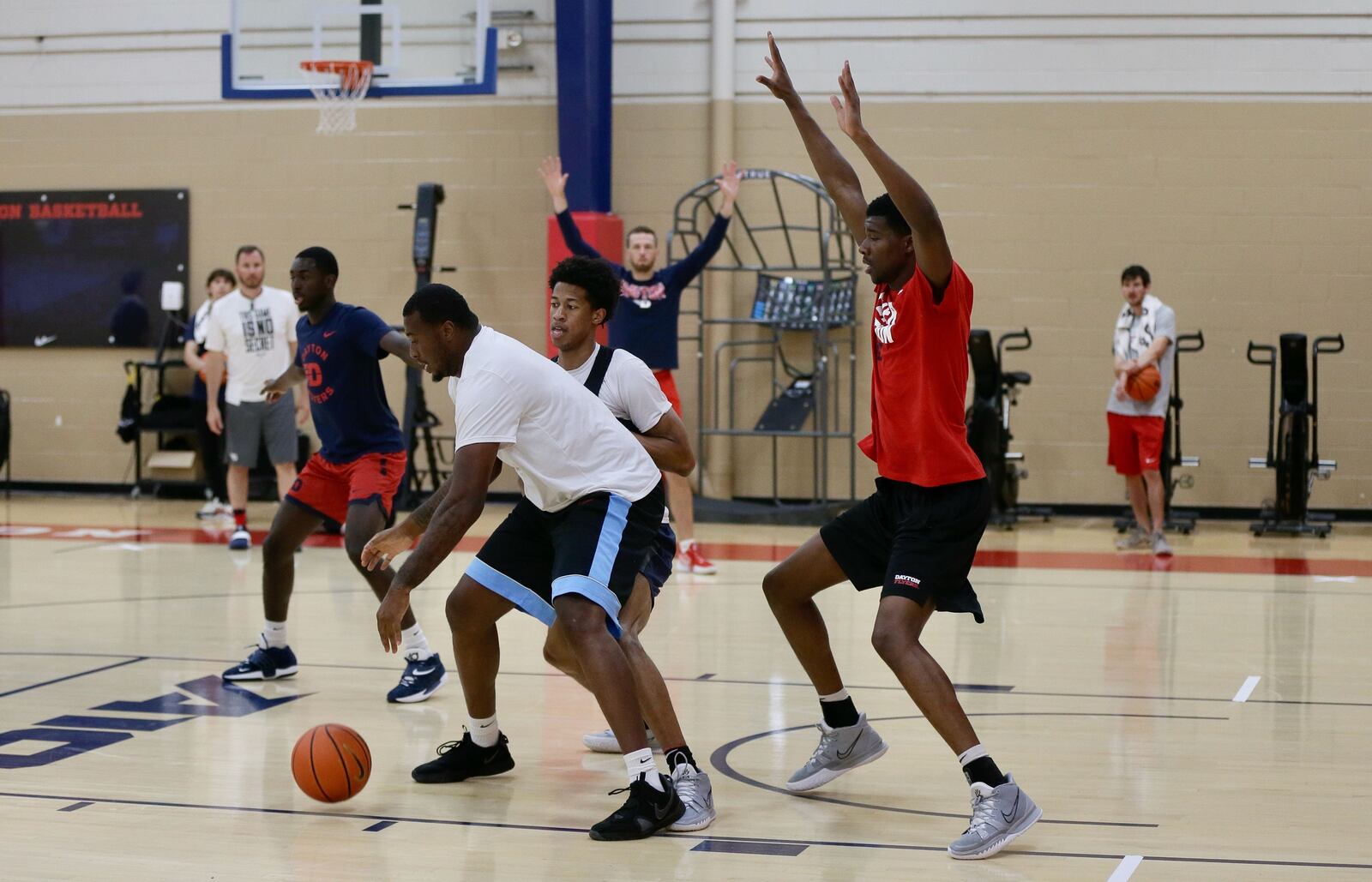 Dayton's Kaleb Washington and Tyrone Baker guard graduate assistant coach Leron Black during a summer practice at the Cronin Center on Monday, Aug. 1, 2022, in Dayton. David Jablonski/Staff