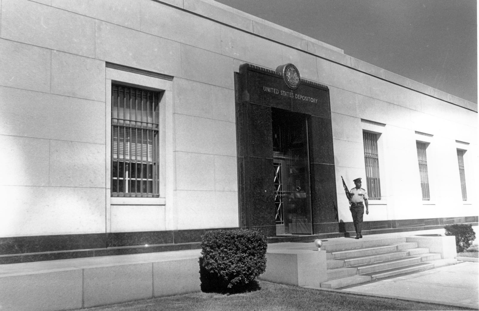 FILE - An armed officer stands guard outside the United States Depository for gold reserves, as the Director of the Mint gives members of Congress a tour in Fort Knox, Kentucky, Sept. 24, 1974. (AP Photo, File)