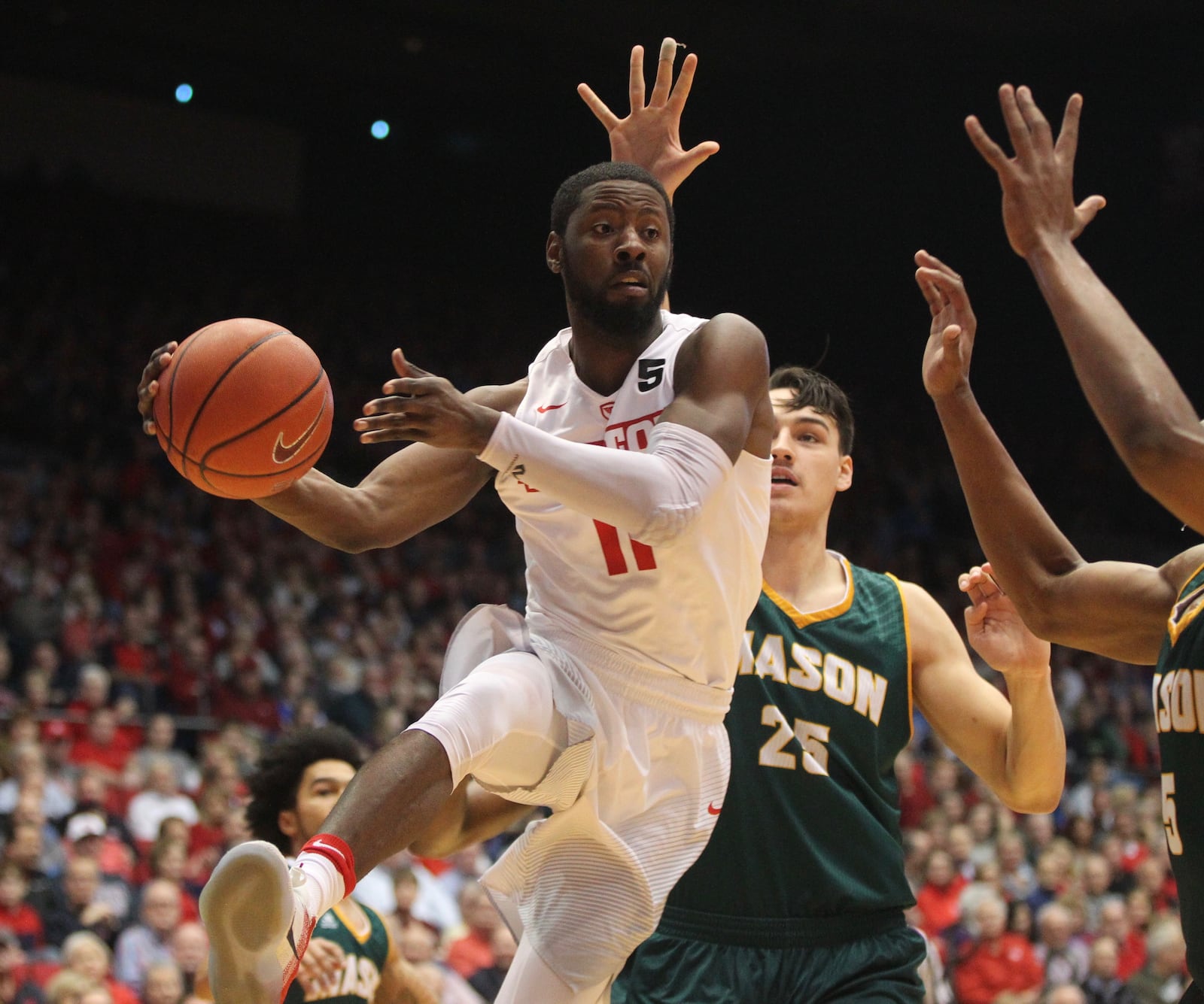 Dayton's Scoochie Smith passes against George Mason on Tuesday, Feb. 21, 2017, at UD Arena. David Jablonski/Staff