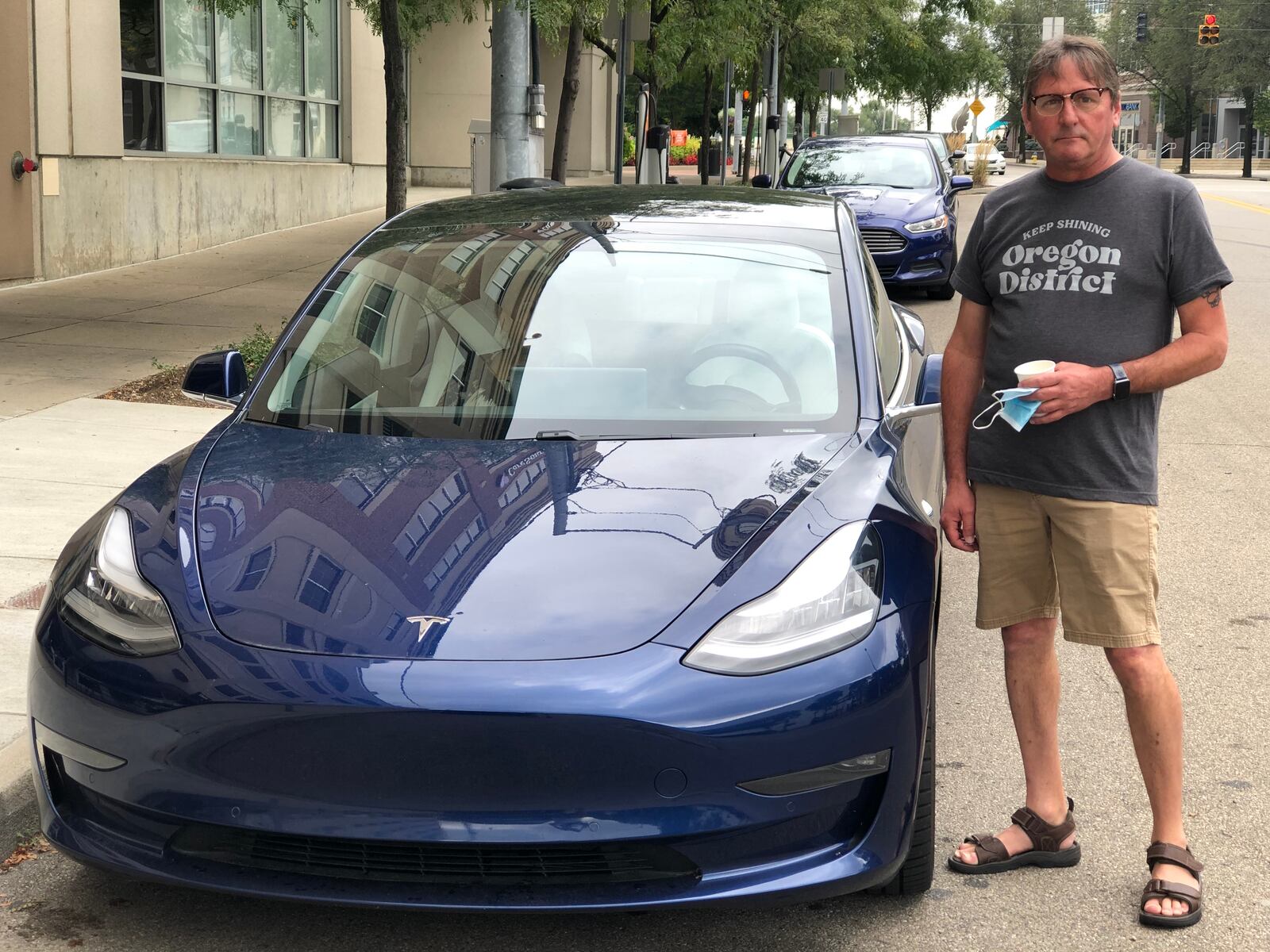 Rob Strong purchased his Tesla about a year ago. He often charges the car at a station across from Day Air Ballpark, where the Dayton Dragons play. CORNELIUS FROLIK / STAFF