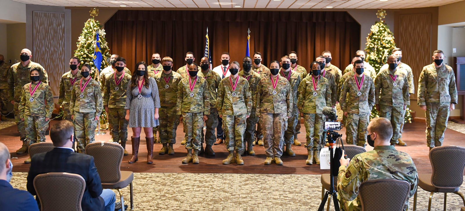 Airman Leadership School Class 22-A poses for a photo with Col. Patrick Miller (far left), 88th Air Base Wing and installation commander, and Chief Master Sgt. Jason Shaffer (far right), 88 ABW command chief, at the end of its graduation ceremony Dec. 2 at Wright-Patterson Air Force Base. ALS is required for staff sergeant selects and open to eligible civilians to gain more knowledge about leadership and Air Force culture. U.S. AIR FORCE PHOTO/JAIMA FOGG