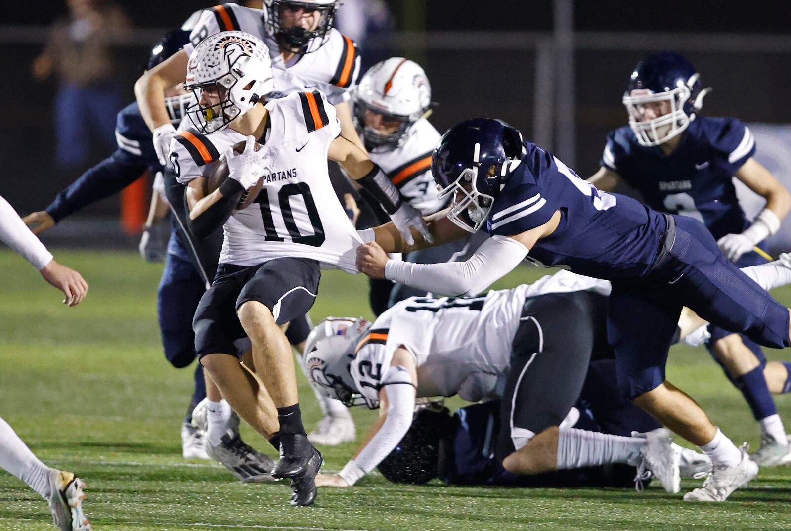 Valley View's Bryce Reed tries to bring down Waynesville's Garrett Lundy during their playoff game at Spingboro Friday, Nov. 17, 2023. BILL LACKEY/STAFF