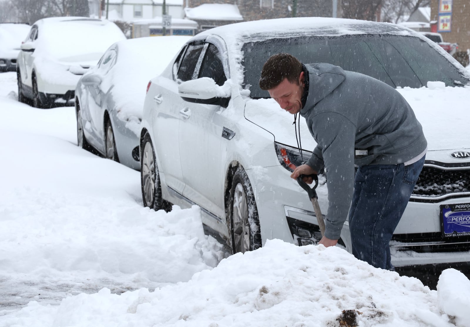 James Thomas shovels his car out of the snow Friday morning along Troy Street in Dayton.