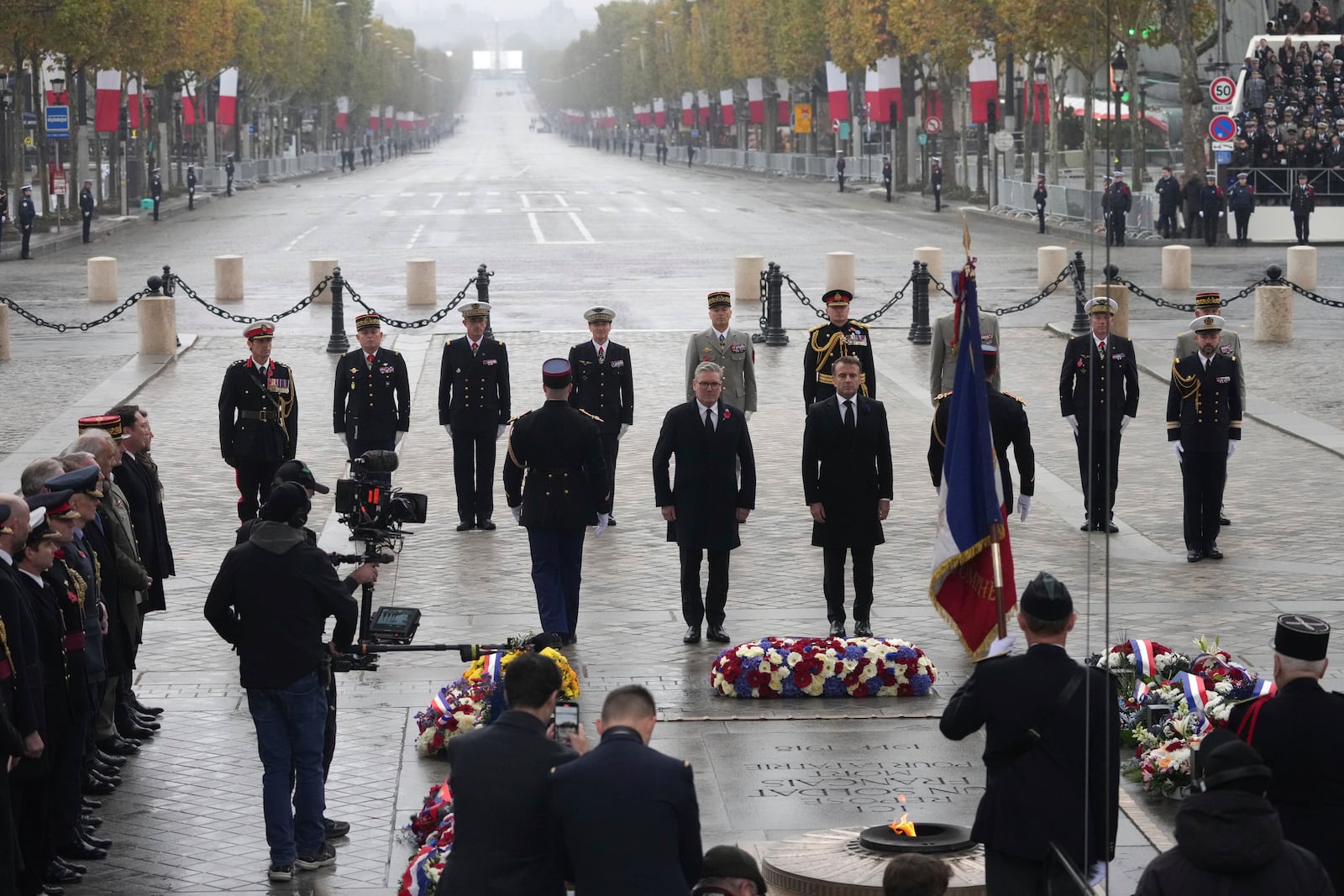 French President Emmanuel Macron, center right, and British Prime Minister Keir Starmer, center left, attend ceremonies marking the 106th anniversary of the Armistice, a celebration of their countries' friendship, as nations across the world pay tribute to their fallen soldiers in World War I, Monday, Nov. 11, 2024 at the Arc de Triomphe in Paris, (AP Photo/Michel Euler, Pool)