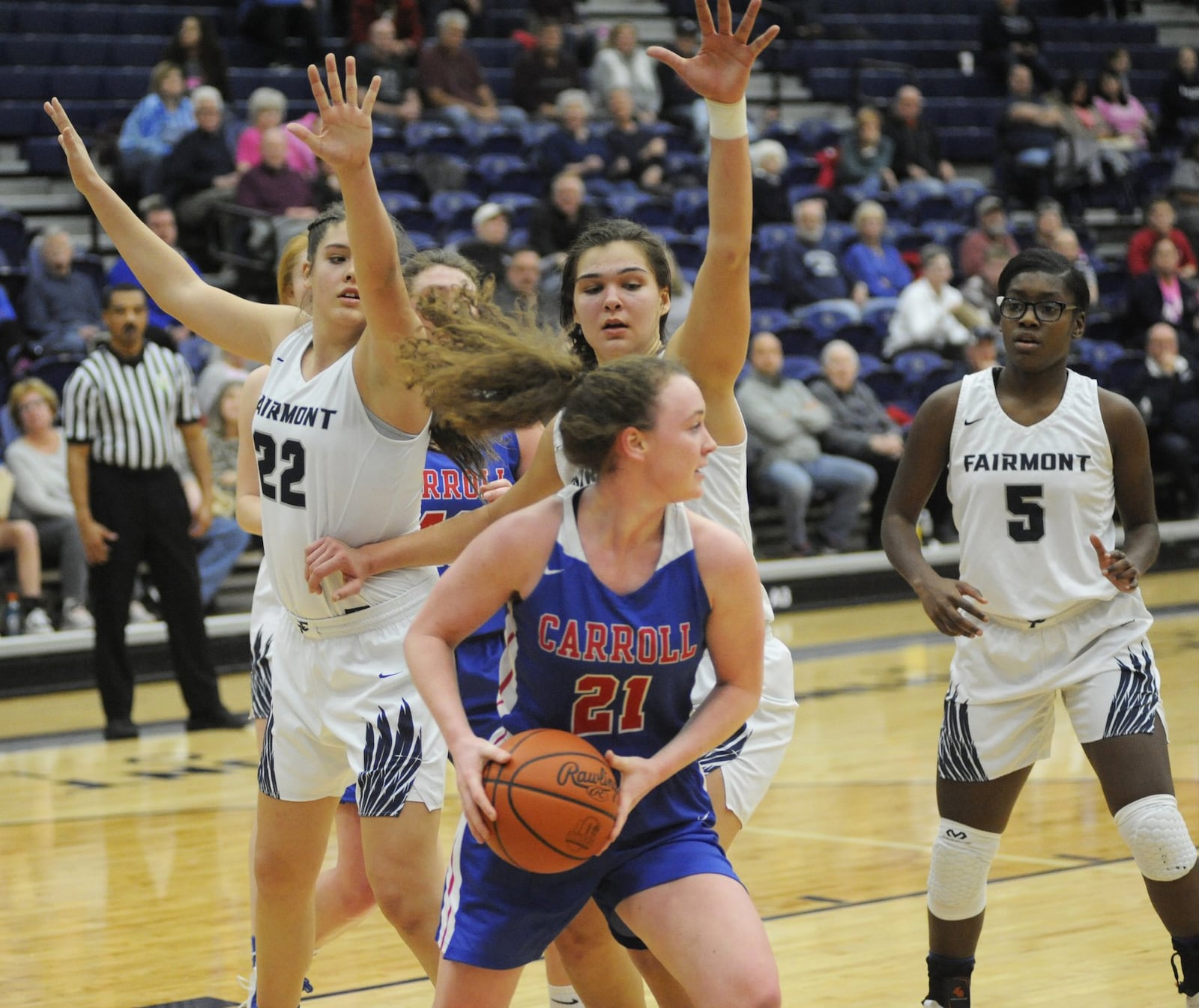 Elisabeth Bush of Carroll (with ball) draws Fairmont defenders Madison Bartley (22), Maddy Westbeld and Kierra Thornton. Carroll defeated host Fairmont 64-60 in double OT in a girls high school basketball game at Trent Arena on Monday, Jan. 28, 2019. MARC PENDLETON / STAFF