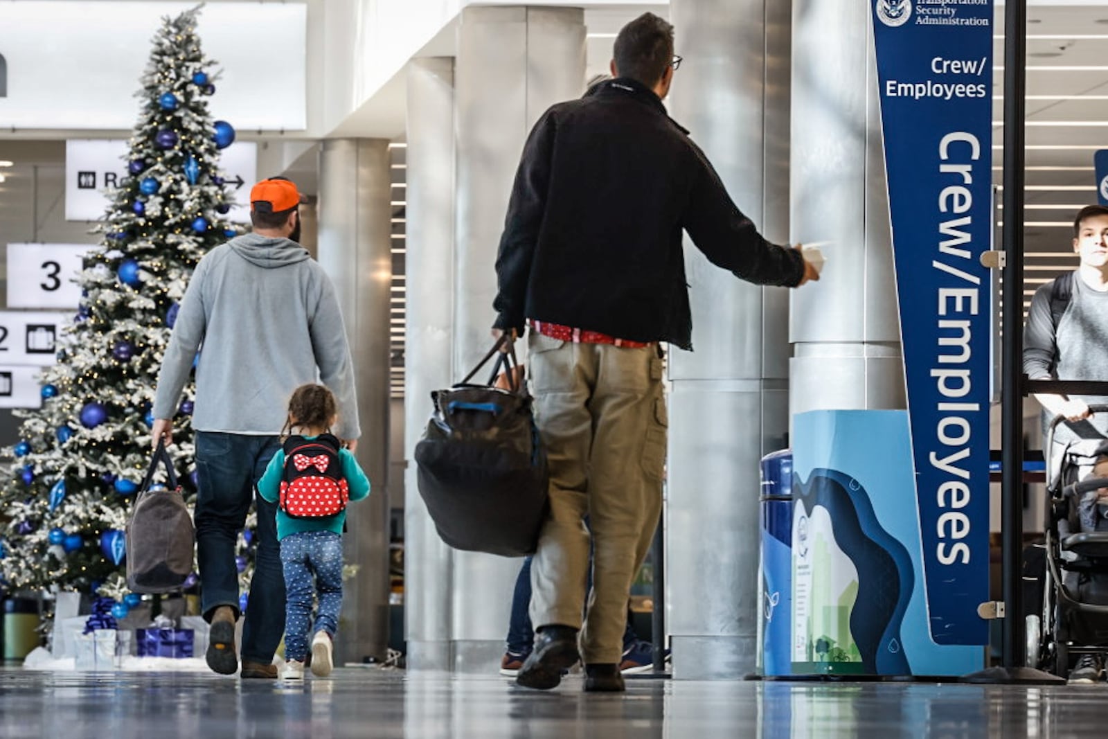 Holiday travelers move through the Dayton International Airport on Tuesday, Dec. 12, 2023. AAA projects 4.7 million Ohioans and more than 389,000 Dayton area residents will travel over the 10-day year-end holiday travel period of Dec. 23, 2023 to Jan. 1, 2024.  JIM NOELKER/STAFF