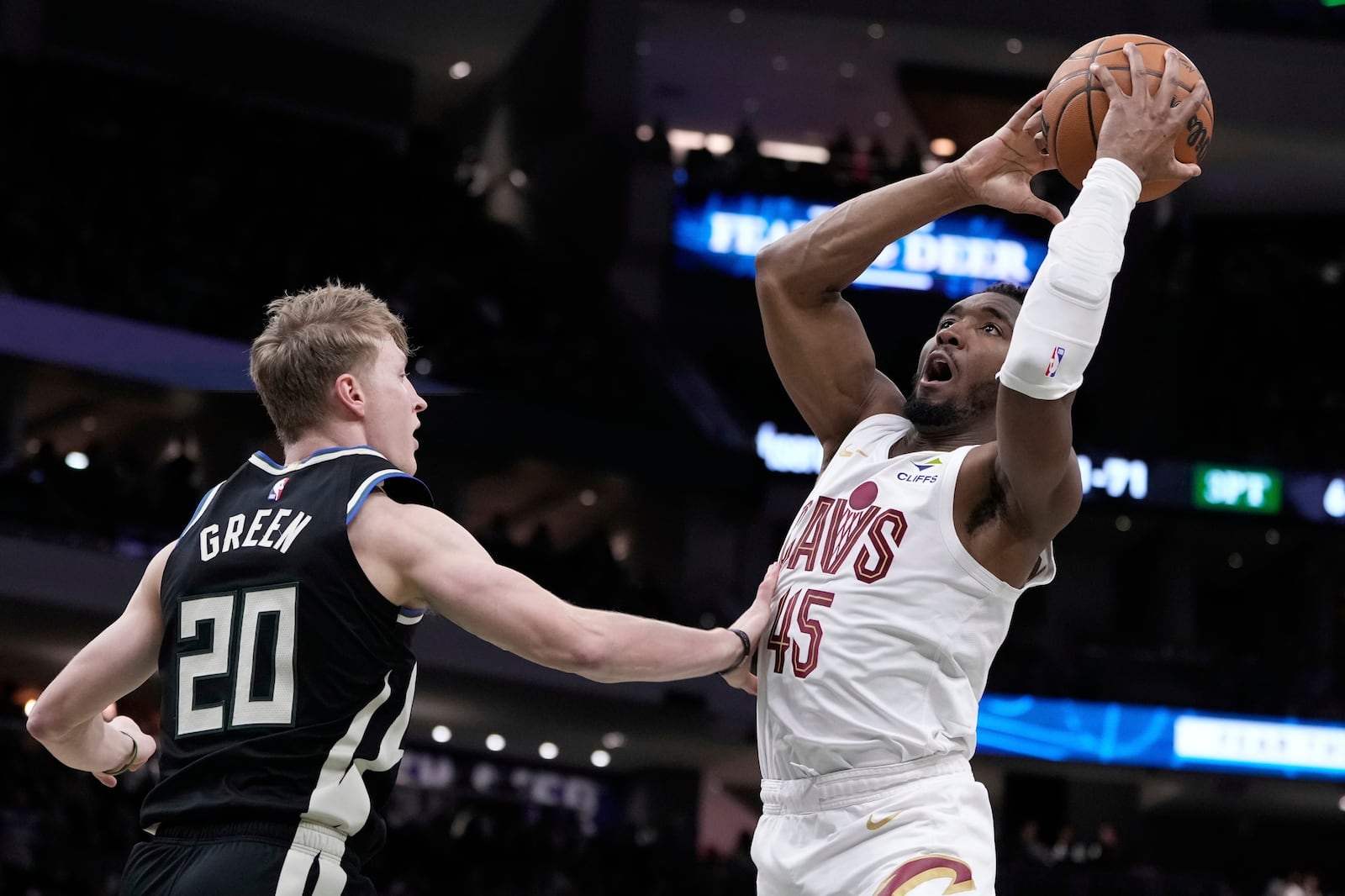 Cleveland Cavaliers' Donovan Mitchell looks to shoot past Milwaukee Bucks' AJ Green during the second half of an NBA basketball game Sunday, March 9, 2025, in Milwaukee. (AP Photo/Morry Gash)