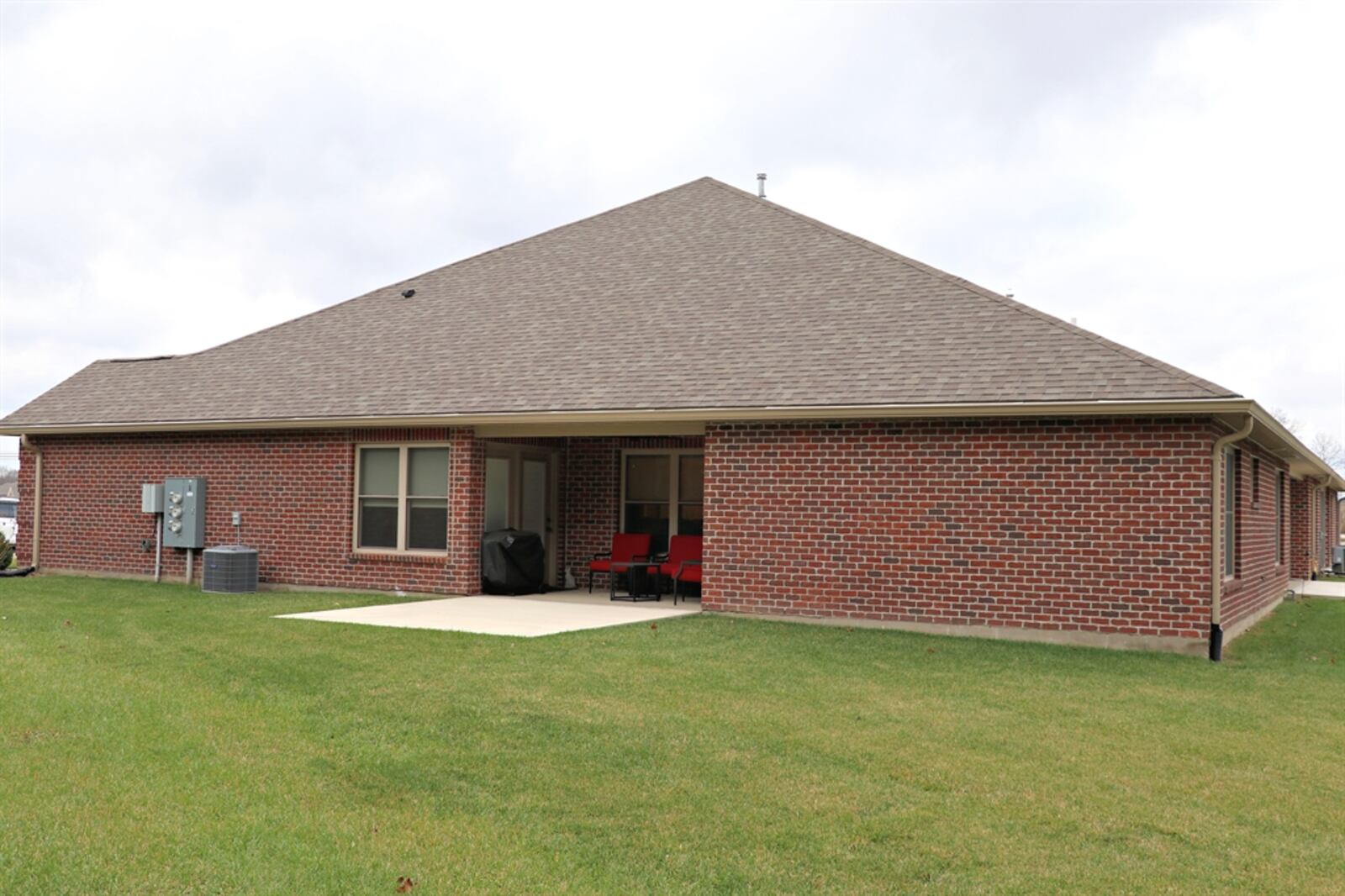 The home has a two-car garage and a covered patio nook with extended sun patio.