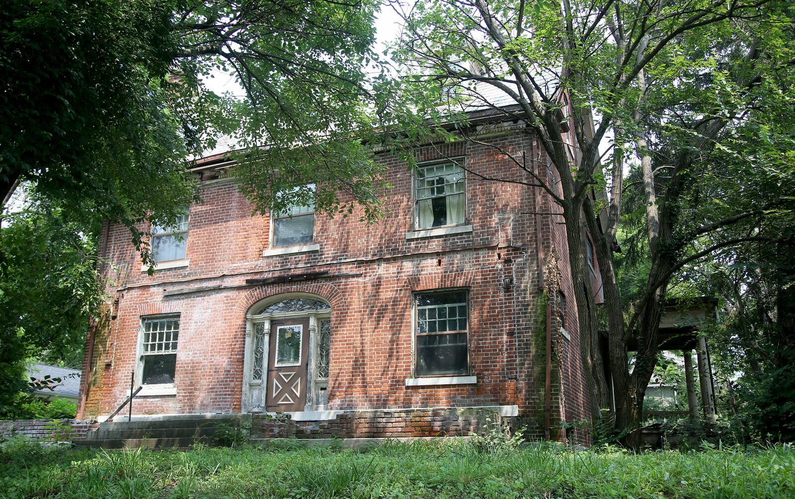 Preservation Dayton Inc., a Dayton non-profit, will attempt to stabilize 10 historic properties in Dayton with the hopes of finding an investor to rehabilitate each one. Judge Edward T. Snediker built this brick Georgian-style home in the Dayton View Historic District in 1905.
Snediker died on Oct 19, 1939. The property was added to the National Register of Historic Places in 1984. LISA POWELL / STAFF
