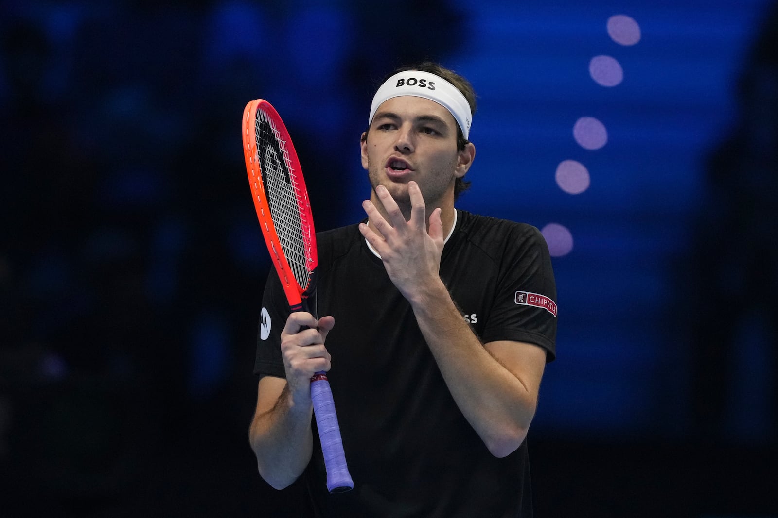 United States' Taylor Fritz reacts during the singles tennis match of the ATP World Tour Finals against Italy's Jannik Sinner, at the Inalpi Arena, in Turin, Italy, Tuesday, Nov. 12, 2024. (AP Photo/Antonio Calanni)