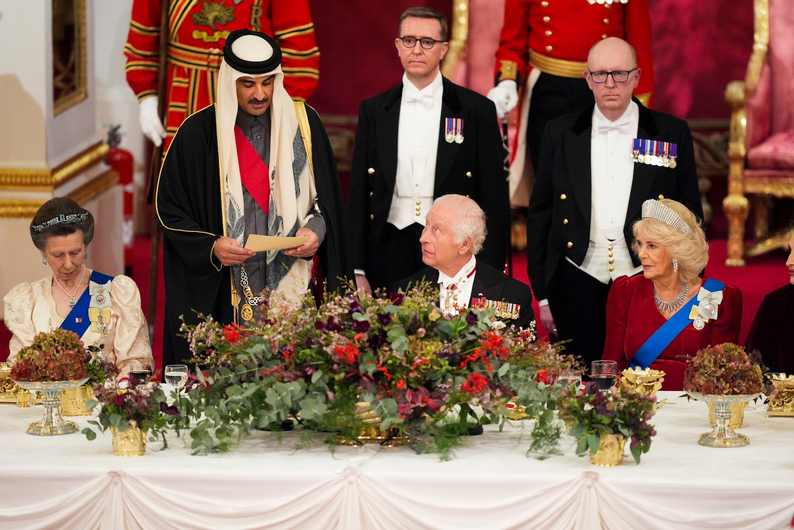 Britain's King Charles III, centre, and Queen Camilla, right, with the Emir of Qatar Sheikh Tamim bin Hamad Al Thani, second left, and Britain's Princess Anne, left, during a State Banquet at Buckingham Palace, in London, Tuesday, Dec. 3, 2024, during the state visit to the U.K. of the Emir of Qatar and the first of his three wives. (Jordan Pettitt/Pool Photo via AP)