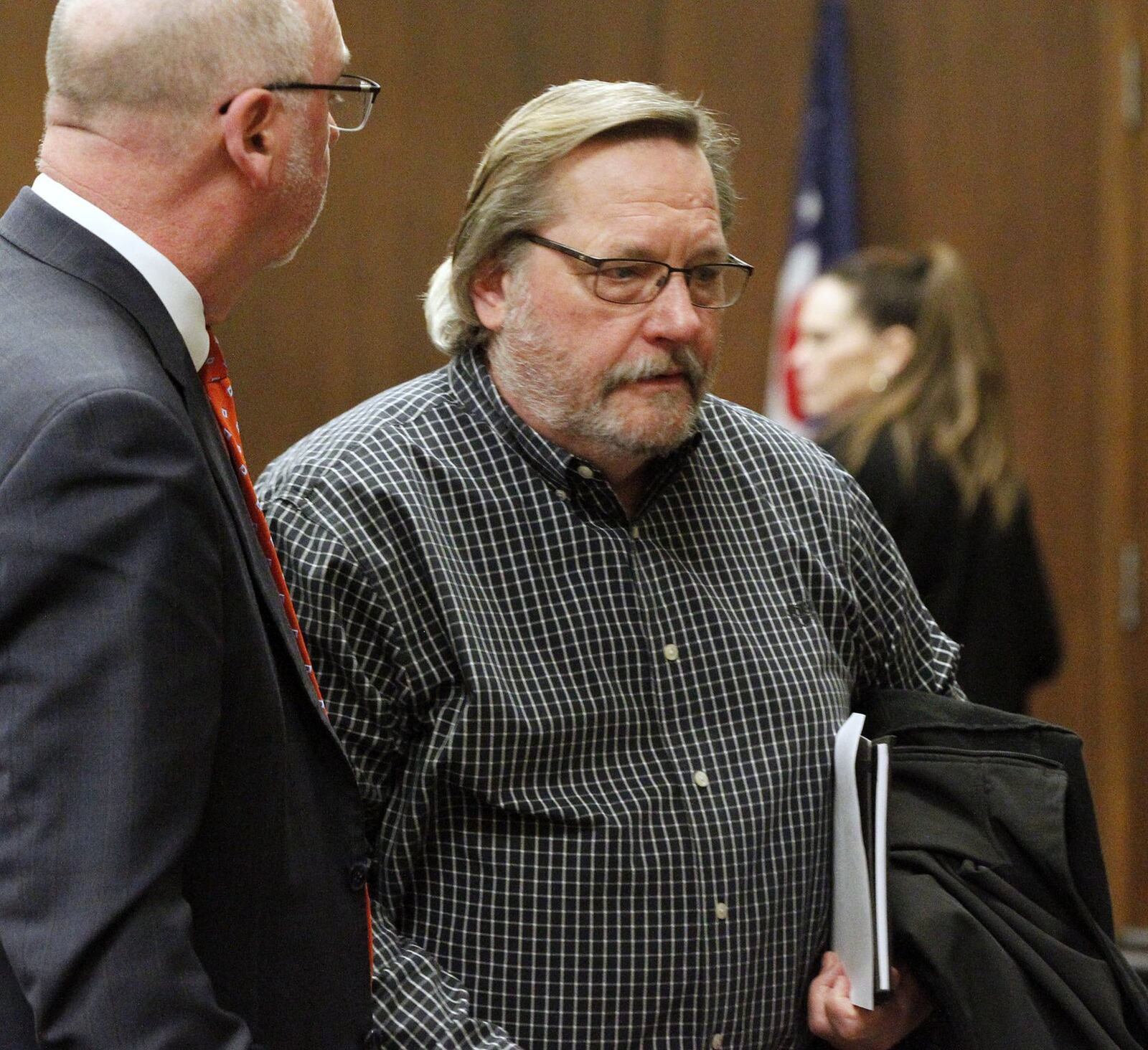 John Gregory Schmidt, right, confers with his attorney Stevey Pierson in the Montgomery County Common Pleas Courtroom of Gregory Singer on Wednesday during a motion to suppress evidence hearing. Schmidt has been indicted for 128 felony counts related to securities fraud from his work as a financial advisor. TY GREENLEES / STAFF