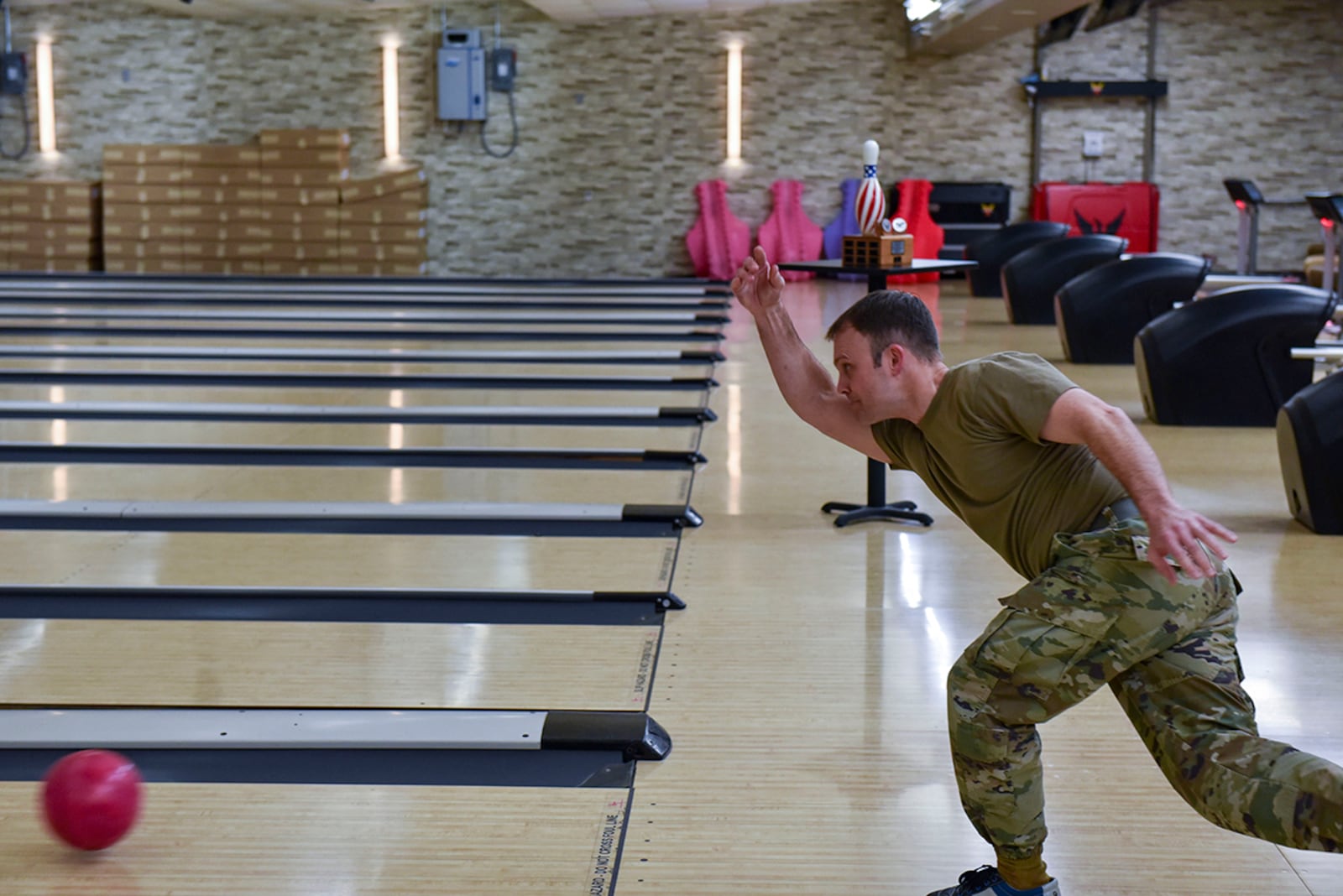 Lt. Col. Joshua Wolfram, 88th Comptroller Squadron commander and 88th Air Base Wing director of staff, throws a ball down the lane during the Eagles vs. Chiefs Bowling Challenge at Wright-Patterson Air Force Base on April 11. U.S. AIR FORCE PHOTO/SENIOR AIRMAN JACK GARDNER