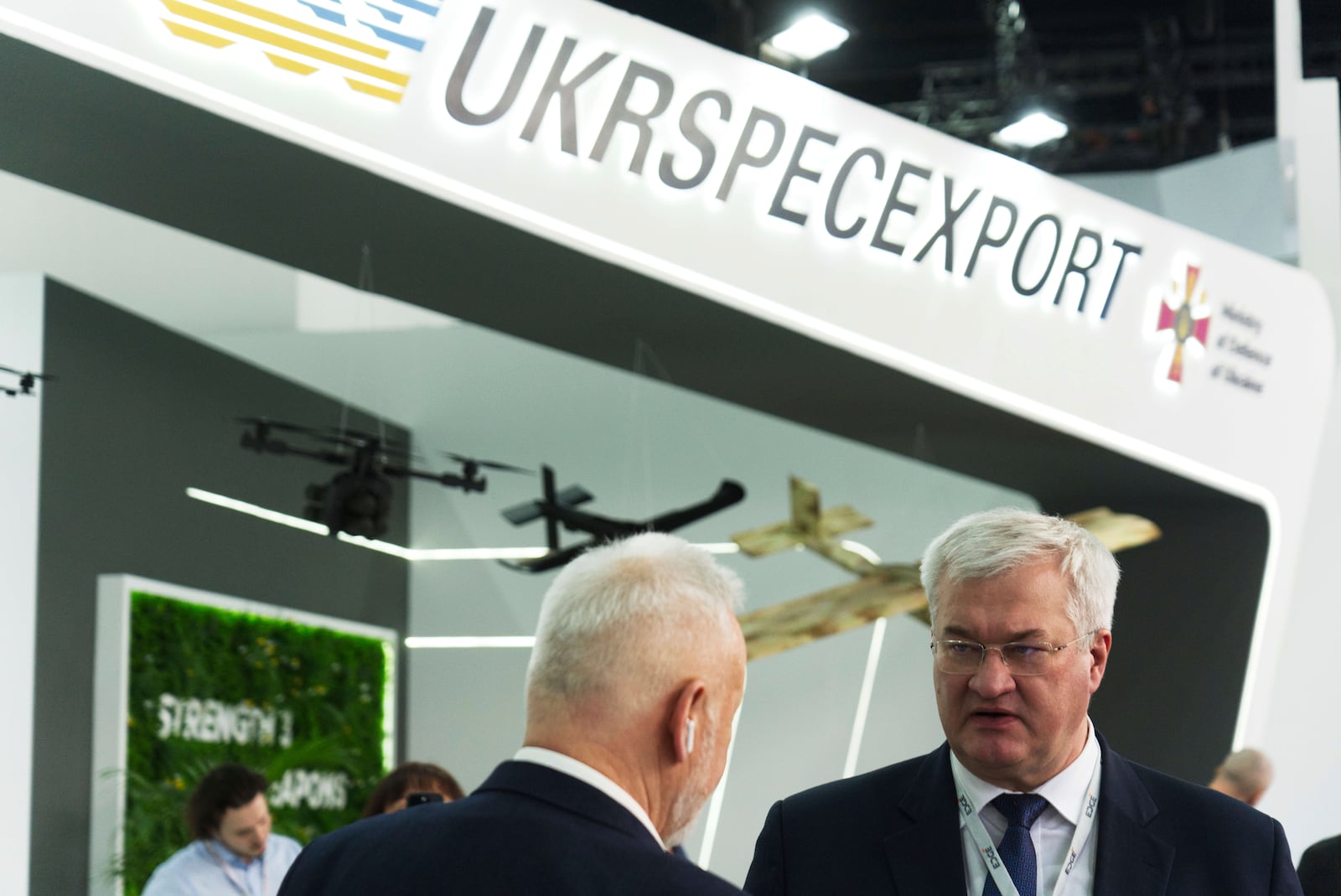 Ukrainian Foreign Minister Andrii Sybiha talks to a man at a stand showing Ukrainian weapons at the biennial International Defense Exhibition and Conference arms show in Abu Dhabi, United Arab Emirates, Monday, Feb. 17, 2025. (AP Photo/Jon Gambrell)