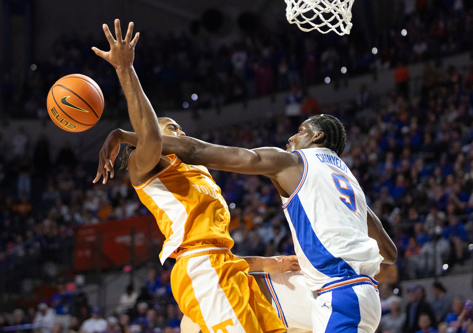 Florida center Rueben Chinyelu (9) blocks Tennessee guard Chaz Lanier, left, during the first half of an NCAA college basketball game Tuesday, Jan. 7, 2025, in Gainesville, Fla. (AP Photo/Alan Youngblood)