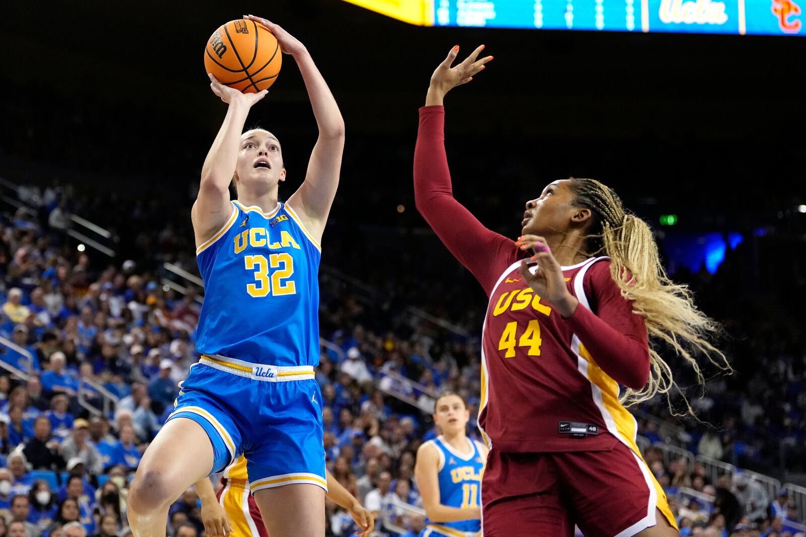 UCLA forward Angela Dugalic, left, shoots as Southern California forward Kiki Iriafen defends during the first half of an NCAA college basketball game Saturday, March 1, 2025, in Los Angeles. (AP Photo/Mark J. Terrill)