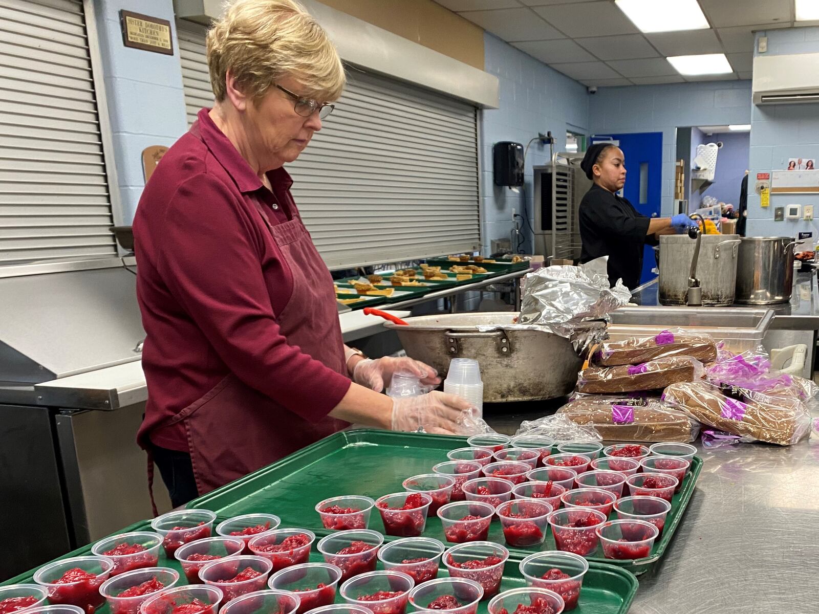 Sue Daum, a volunteer at House of Bread, works on cranberry sauce before the House of Bread Thanksgiving lunch on Thursday, Nov. 24, 2022. Eileen McClory / STAFF