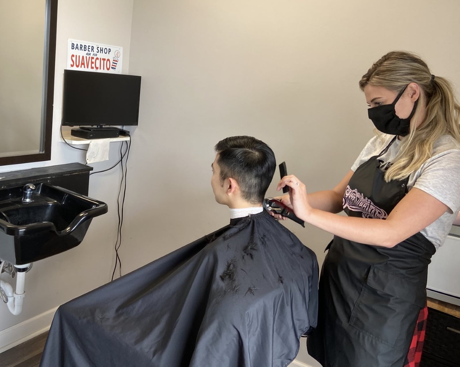 Stylist Sherry Myers cuts customer Matthew Pyo’s hair at Hair Force Barber Shop and Salon in Beavercreek on Friday. It was the first time in two months that salons and barbershops were allowed to open as part of the next phase of the governor s gradual re-opening of nonessential businesses.