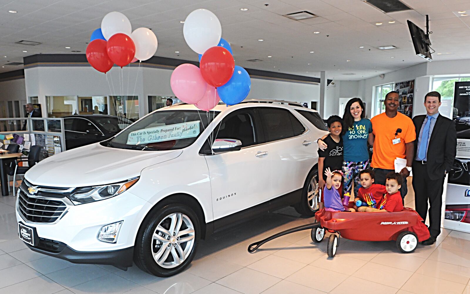 The Gibson Family with Jay Schmitt picking up their new car at the Jeff Schmitt Auto Group in Fairborn in this 2017 photo. The car was a gift from Ellen DeGeneres and Chevrolet. Photo Marshall Gorby