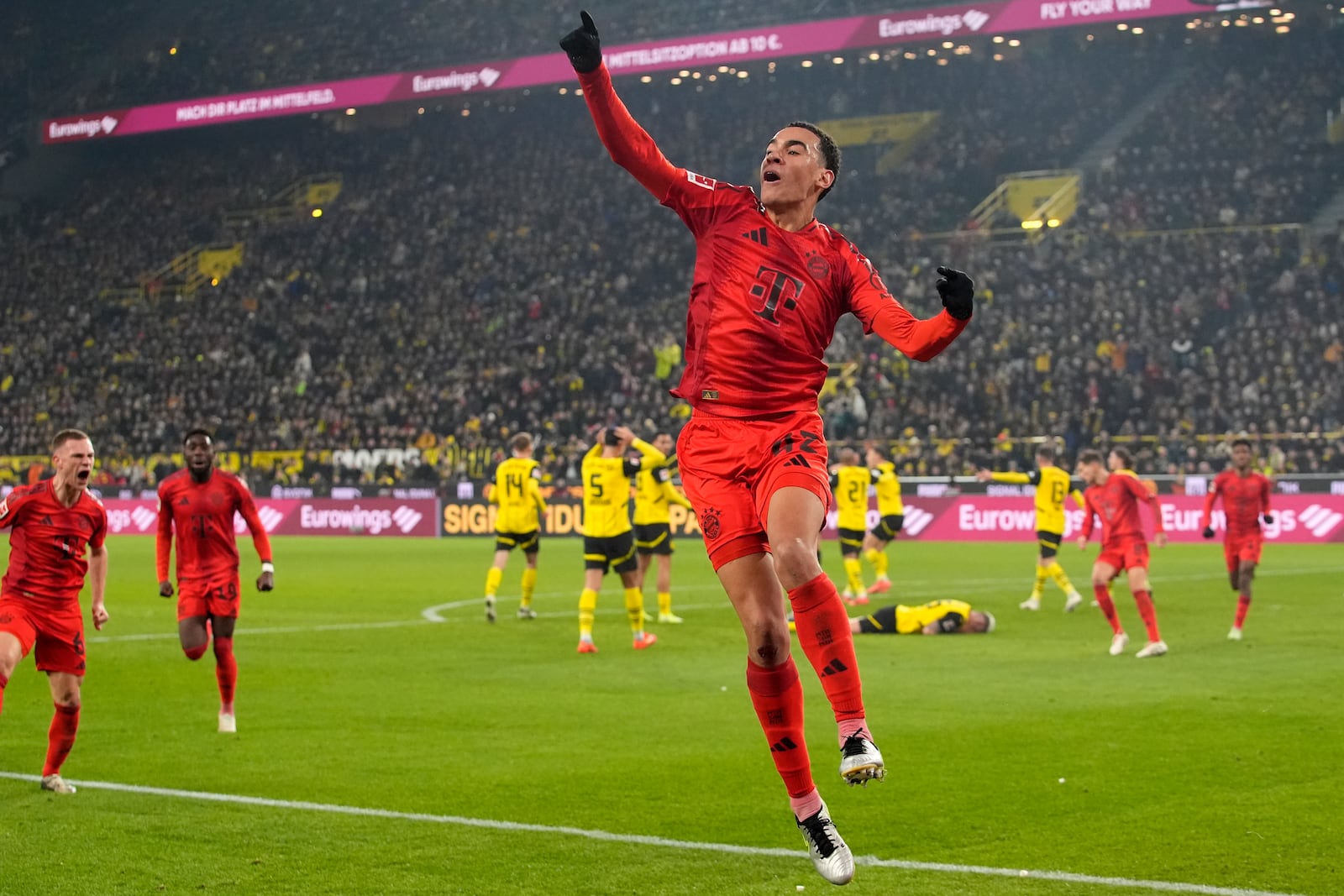 Bayern's Jamal Musiala celebrates after scoring during the German Bundesliga soccer match between Borussia Dortmund and Bayern Munich at the Signal-Iduna Park in Dortmund, Germany, Saturday, Nov. 30, 2024. (AP Photo/Martin Meissner)