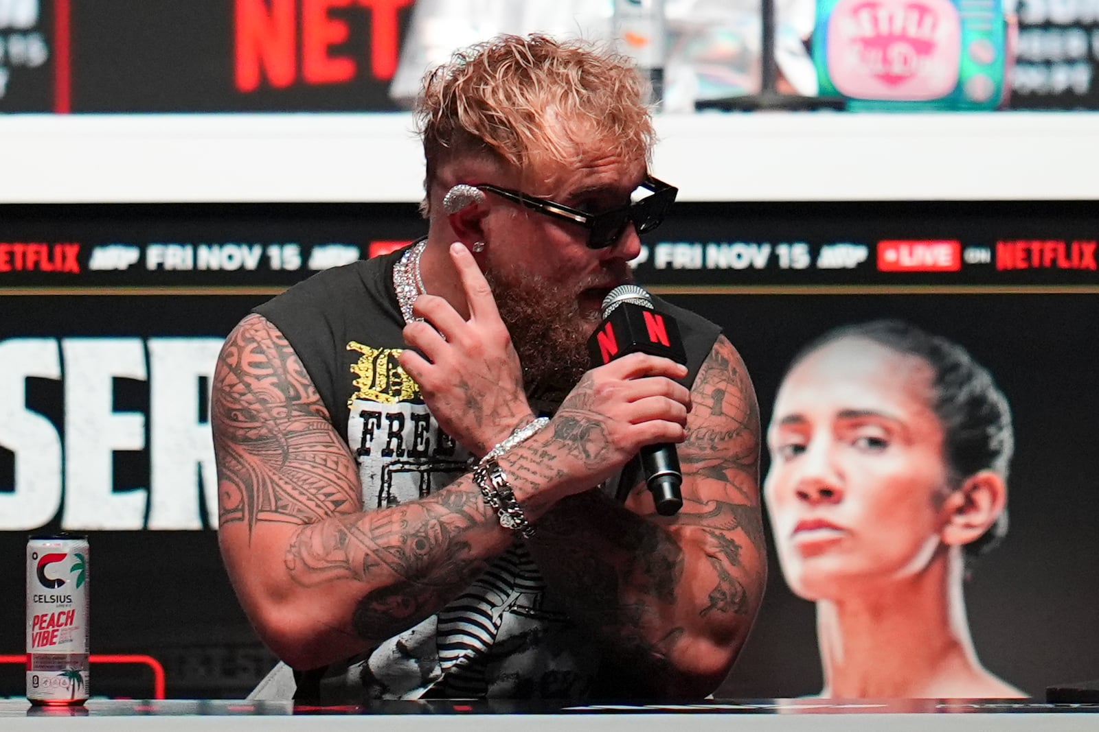 Jake Paul addresses a question about an item he wears on his ear during a news conference ahead of his fight against Mike Tyson, Wednesday, Nov. 13, 2024, in Irving, Texas. (AP Photo/Julio Cortez)