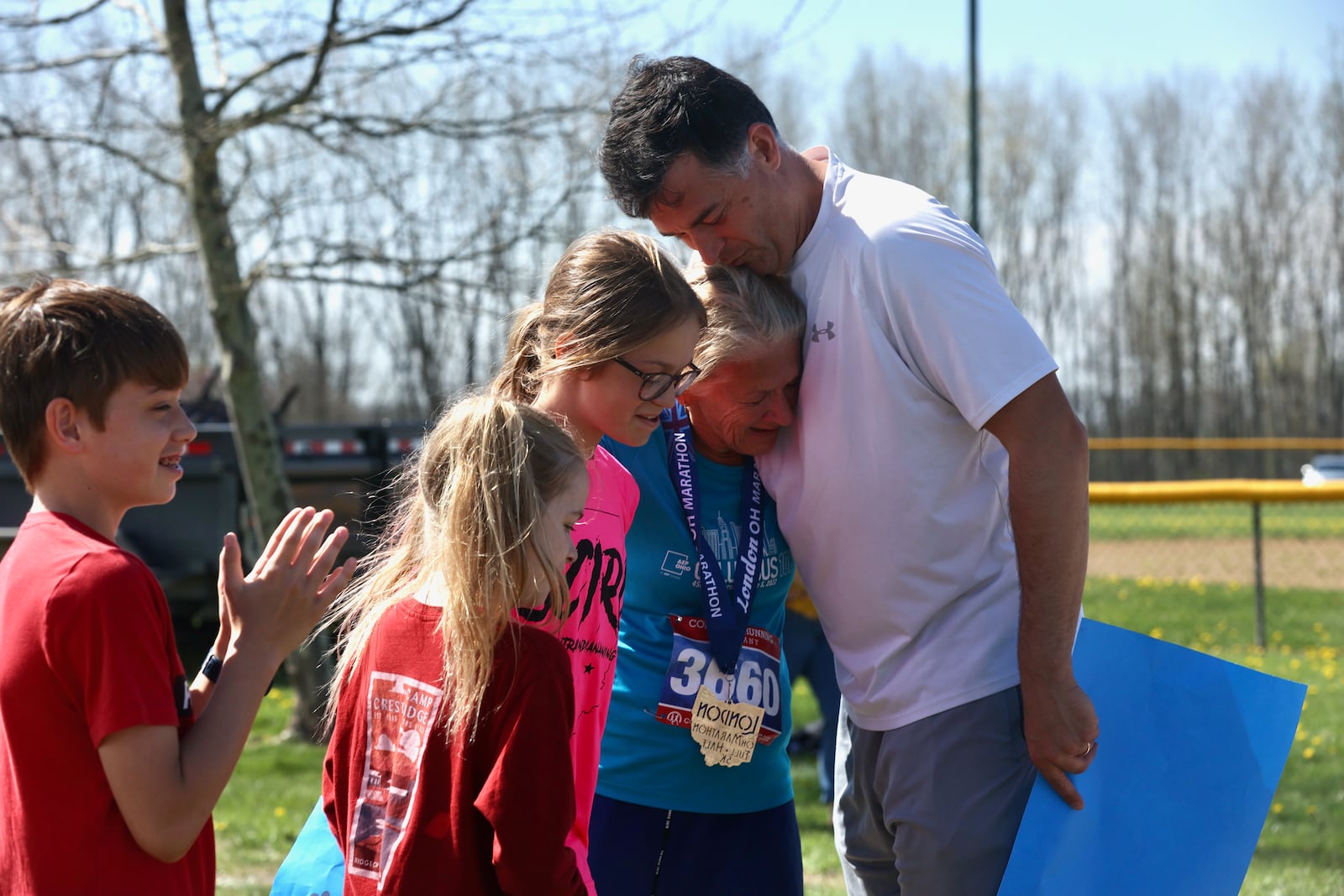 Mary Jablonski hugs her son Adam, righjt, after finishing the London Marathon on April 15, 2023, in London, Ohio. David Jablonski/Staff