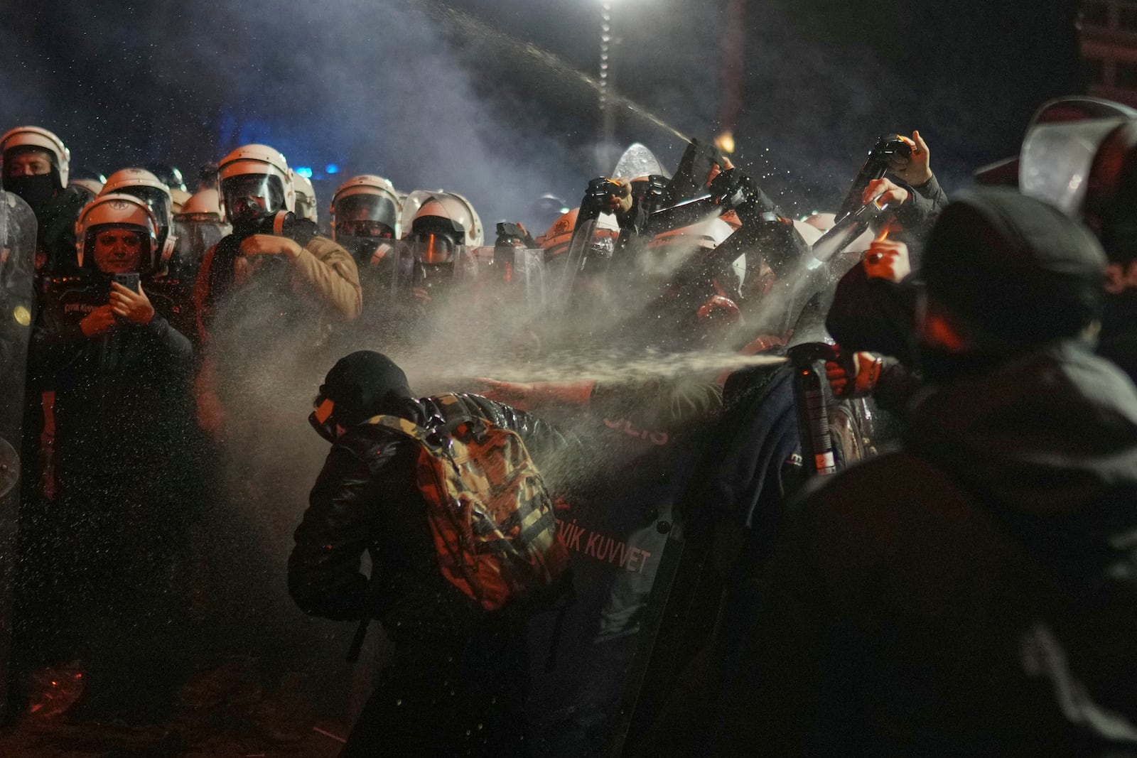 Riot police use pepper spray to clear a protester during a protest against the arrest of Istanbul's Mayor Ekrem Imamoglu, in Istanbul, Turkey, Saturday, March 22, 2025. (AP Photo/Francisco Seco)