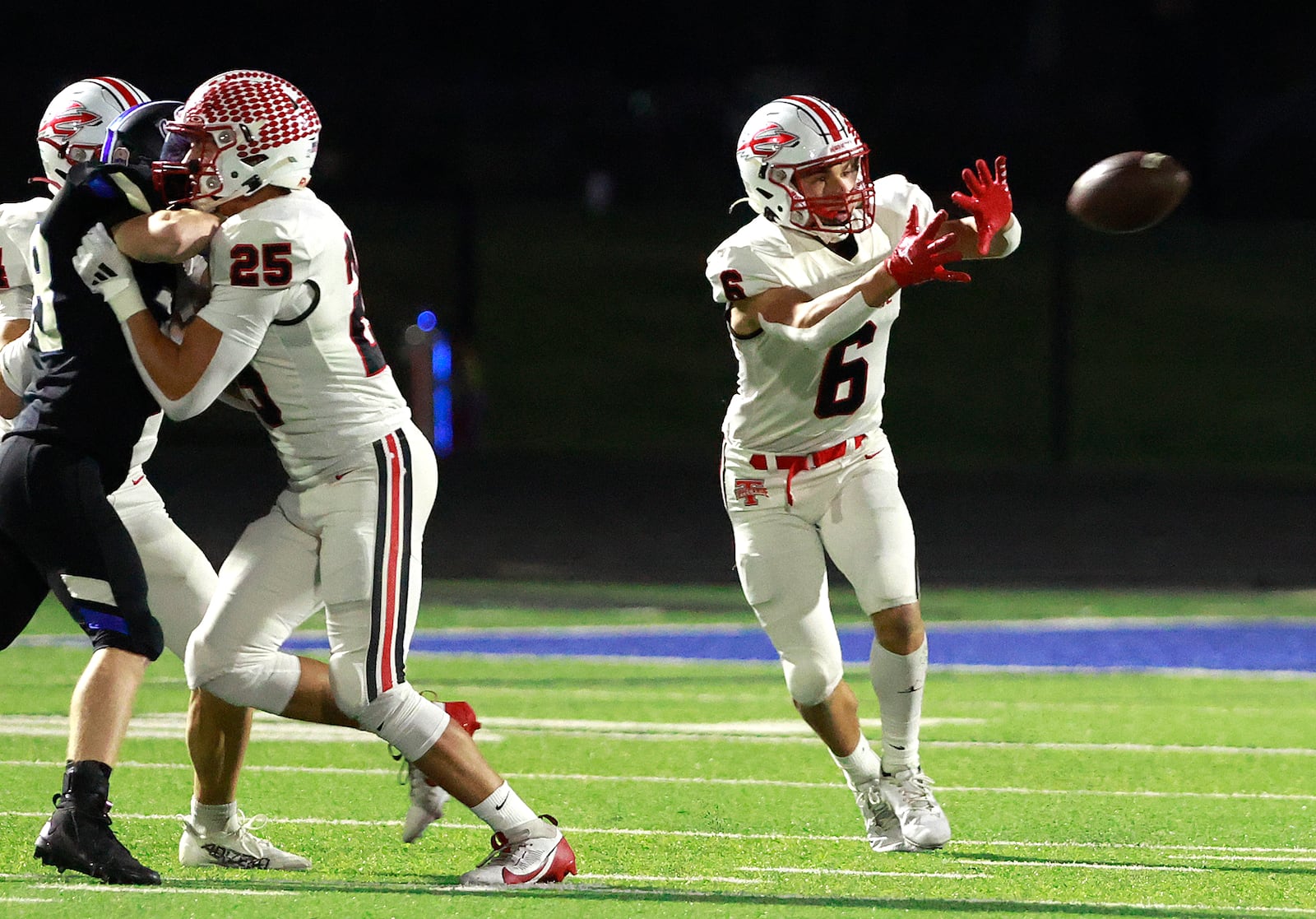 Tipp's Jackson Davis catches a pass behind a block by his teammate Cade Havill during Friday's game.