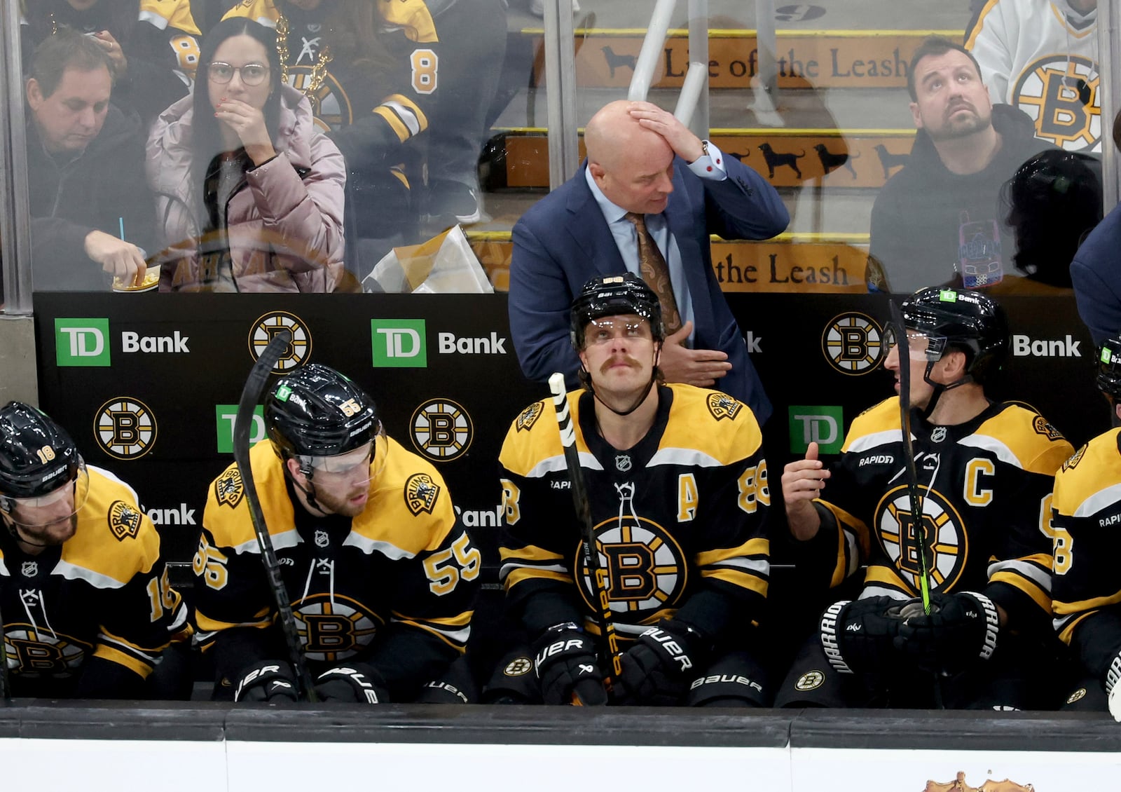 Boston Bruins head coach Jim Montgomery speaks to one of his players during the second period of an NHL hockey game against Seattle Kraken, Sunday, Nov. 3, 2024, in Boston. (AP Photo/Mark Stockwell)