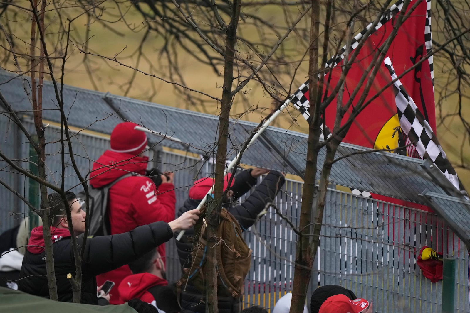 People gather outside the Ferrari track as British driver Lewis Hamilton tests a Ferrari Formula One SF-23, in Fiorano Modenese, Italy, Wednesday, Jan. 22, 2025. (AP Photo/Luca Bruno)