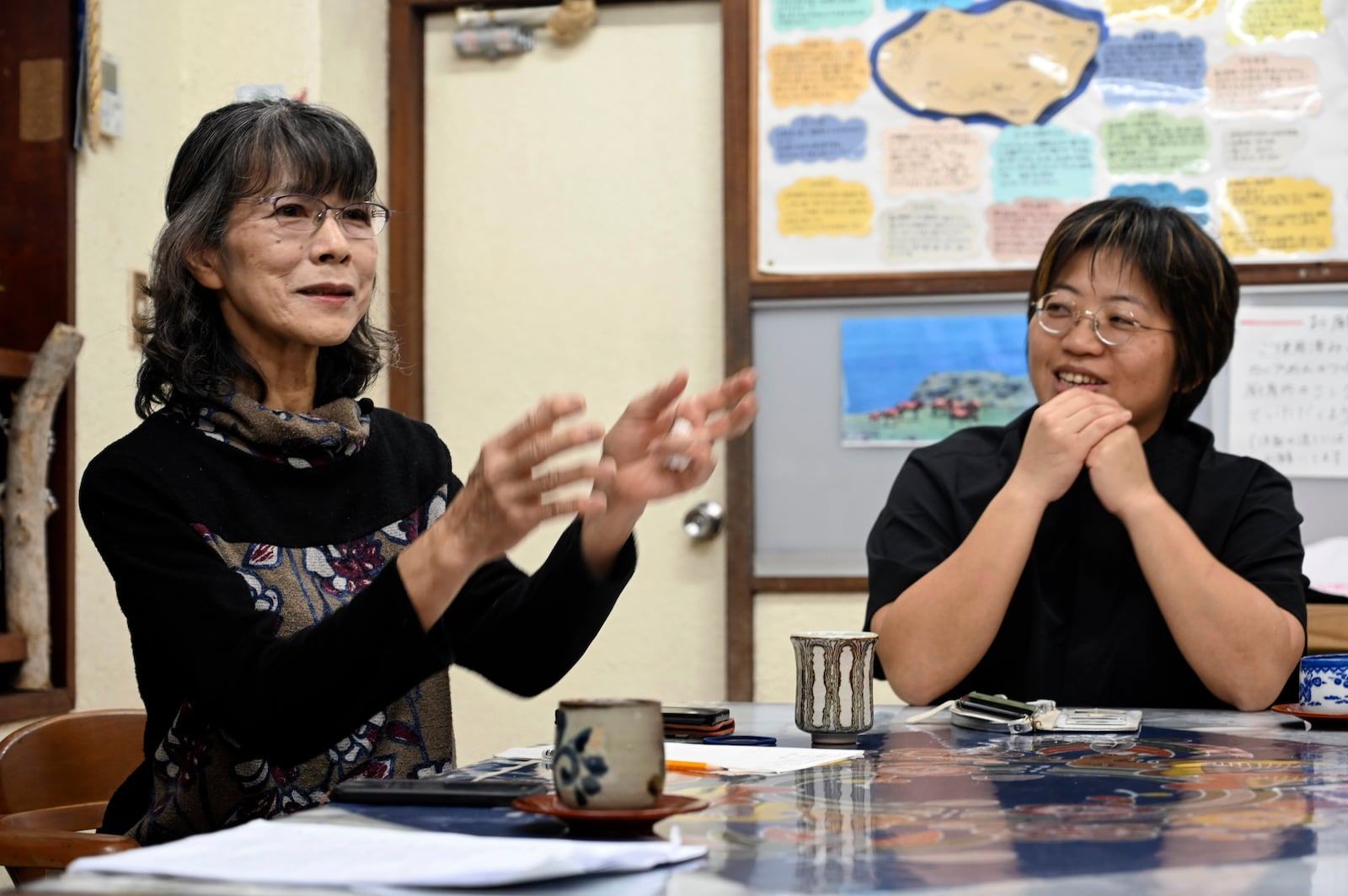 Fumie Kano, left, and Takako Ueno, who oppose the presence of the Japan Self-Defense Forces (JSDF) base on Yonaguni island, talk during an interview with the AP on Yonaguni, a tiny island on Japan’s western frontier, Friday, Feb. 14, 2025. (AP Photo/Ayaka McGill)