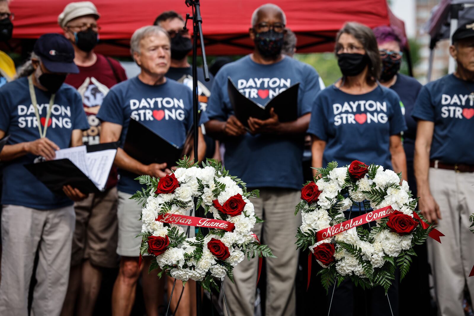 Members of the World House Choir sings during a remembrance event on the third anniversary of the Oregon District mass shooting Thursday, Aug. 4, 2022. The Yellow Springs choir sings about justice and peace, JIM NOELKER/STAFF