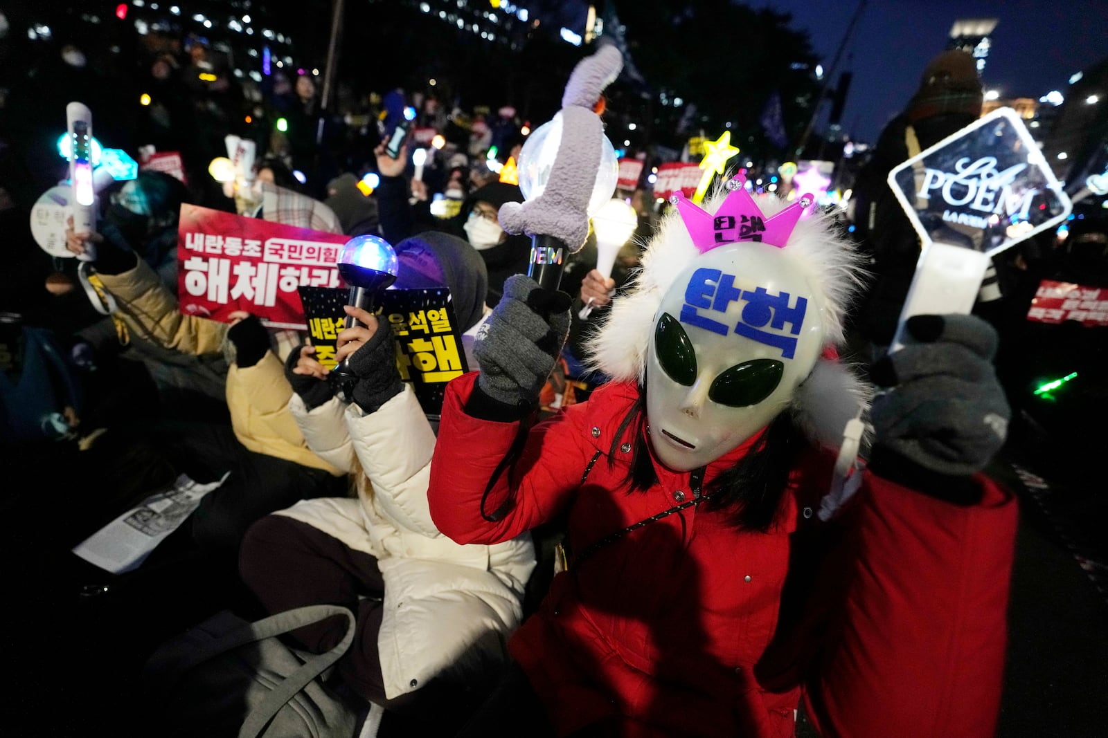 Participants attend a rally to demand South Korean President Yoon Suk Yeol's impeachment outside the National Assembly in Seoul, South Korea, Friday, Dec. 13, 2024. (AP Photo/Ahnn Young-joon)