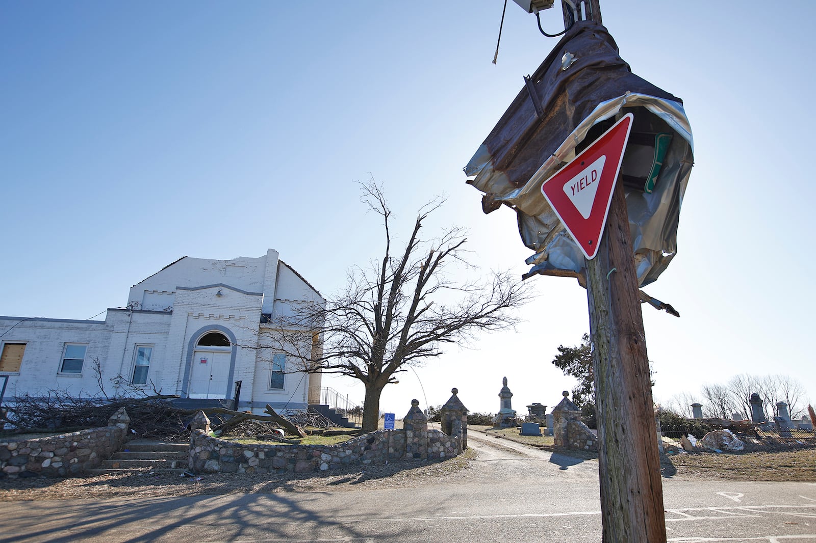 Metal is wrapped around a utility pole in front of the damaged Fletcher-Chapel Church in Clark County Thursday, Feb. 29, 2024. BILL LACKEY/STAFF