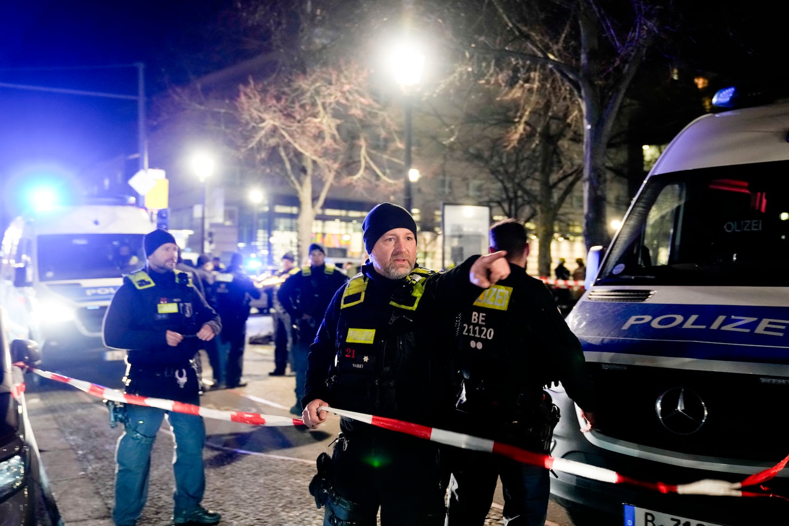 Police officers attend the scene at the Holocaust memorial after a man was attacked at the memorial site in Berlin, Germany, Friday, Feb. 21, 2025. (AP Photo/Ebrahim Noroozi)