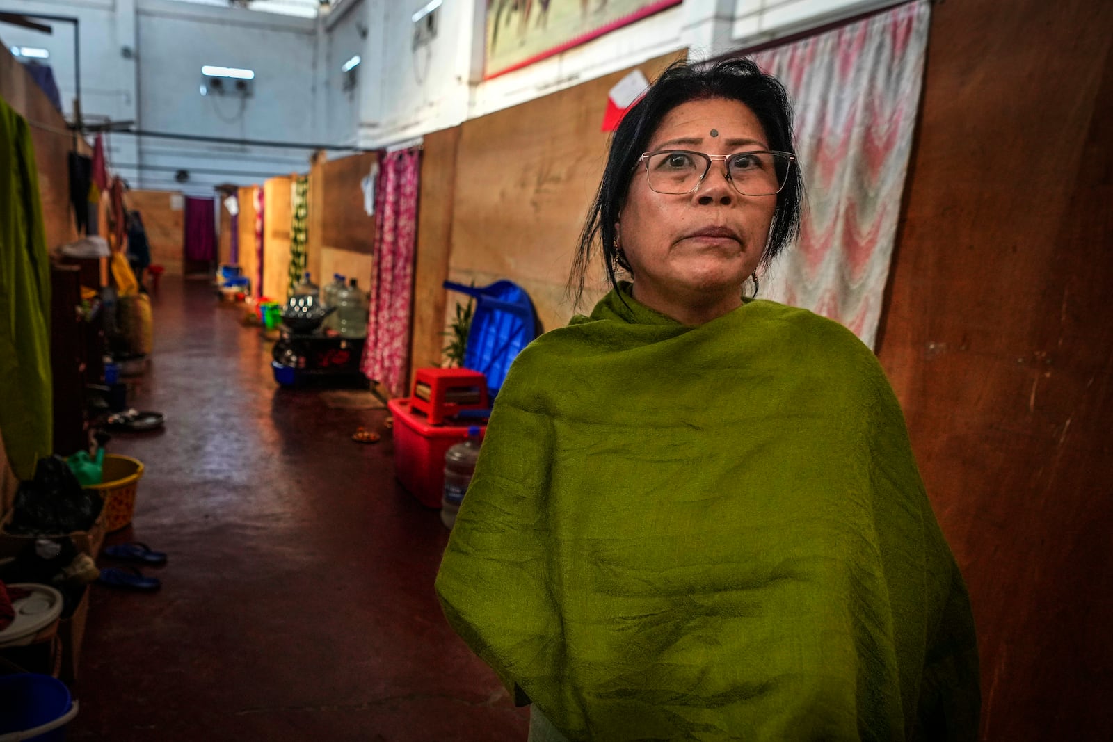 Yengsom Junksom Memi, a Meitei, talks to Associated Press n a relief camp in Imphal, Manipur, Monday, Dec. 16, 2024. Mimi, used to live in Kangpokpi when attackers rampaged her home and forced her family to run for their lives, Memi first took refuge in a police station, before moving to a relief center in Imphal where she lives with other 600 displaced Meiteis. She said her house has since been taken over by the attackers. (AP Photo/Anupam Nath)