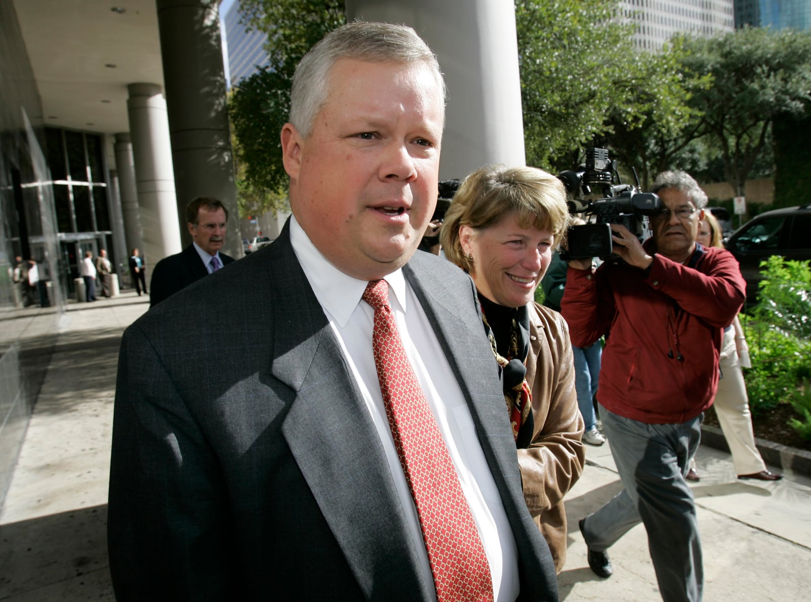 FILE - Richard Causey, Enron's former chief accounting officer, leaves the federal courthouse with his wife Elizabeth after being sentenced to five-and-a-half years in prison Wednesday, Nov. 15, 2006 in Houston. (AP Photo/David J. Phillip, File)