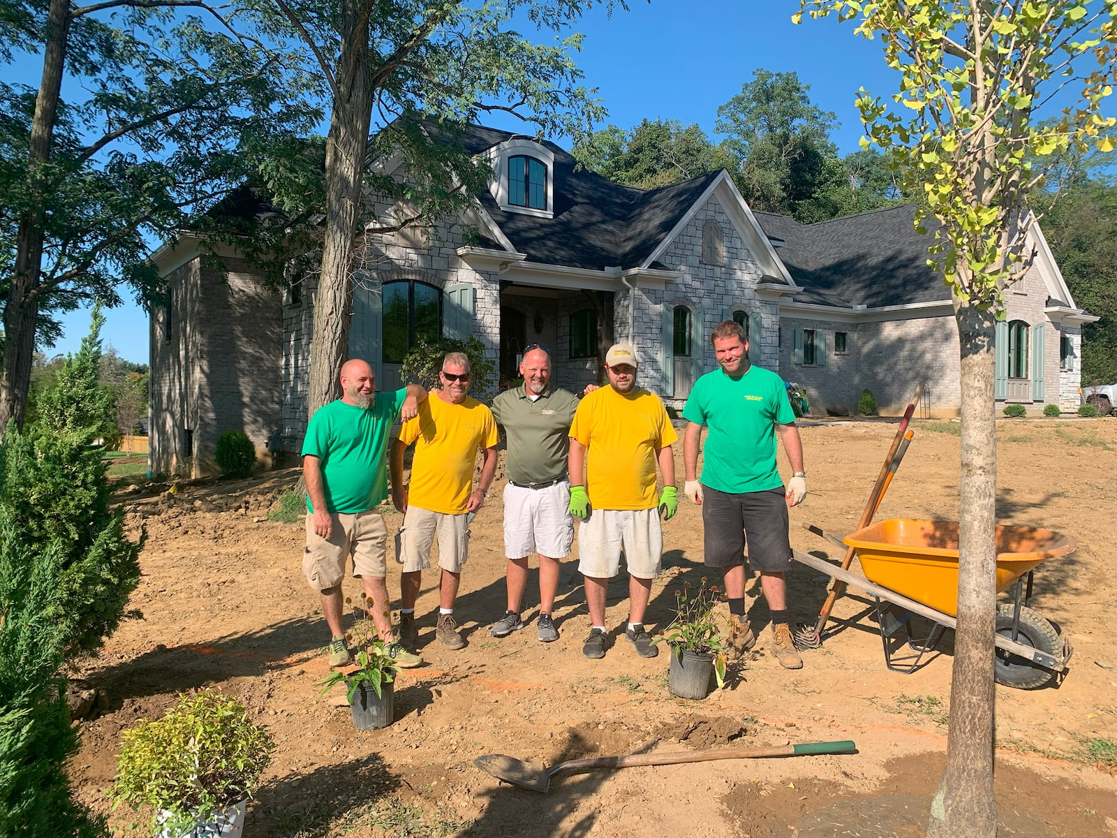 The landscaping crew from Gold-n-Touch Landscaping with owner-president Skip Coleman finish working on the lot prior to move-in day. Coleman is a graduate of Stebbins High School.