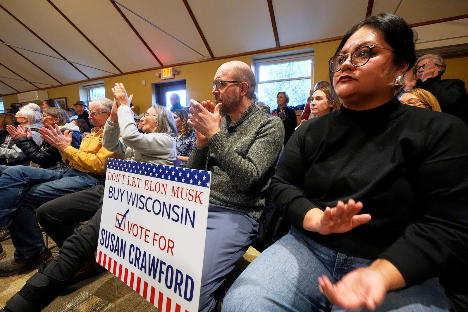 People applaud during a town hall meeting at the George Culver Community Library Thursday, March 6, 2025, in Sauk City, Wis. (AP Photo/Morry Gash)