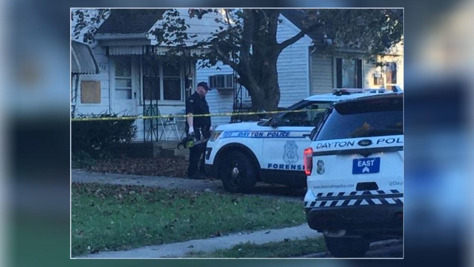 A Dayton police investigator carries a chainsaw from a death investigation on South Hedges Avenue. (Sean Cudahy/Staff)