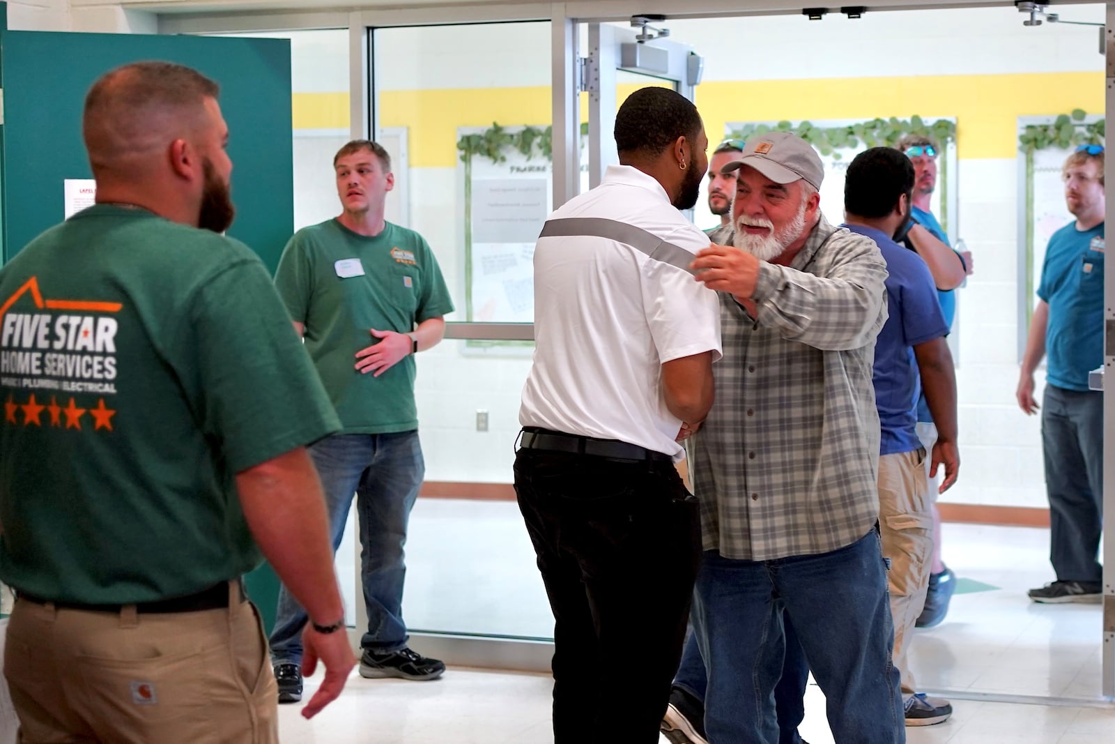 Five Star Heating and Cooling CEO Kip Morris shakes hands with employees onsite at Emerge Recovery and Trade Initiative, which his company sponsors. CONTRIBUTED