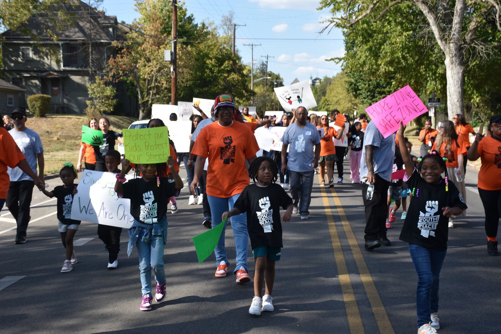 Kids, teens and adults marched down Broadway Street in northwest Dayton on Thursday as part of a peace march and rally in response to an increase in gun violence in the community. CORNELIUS FROLIK / STAFF