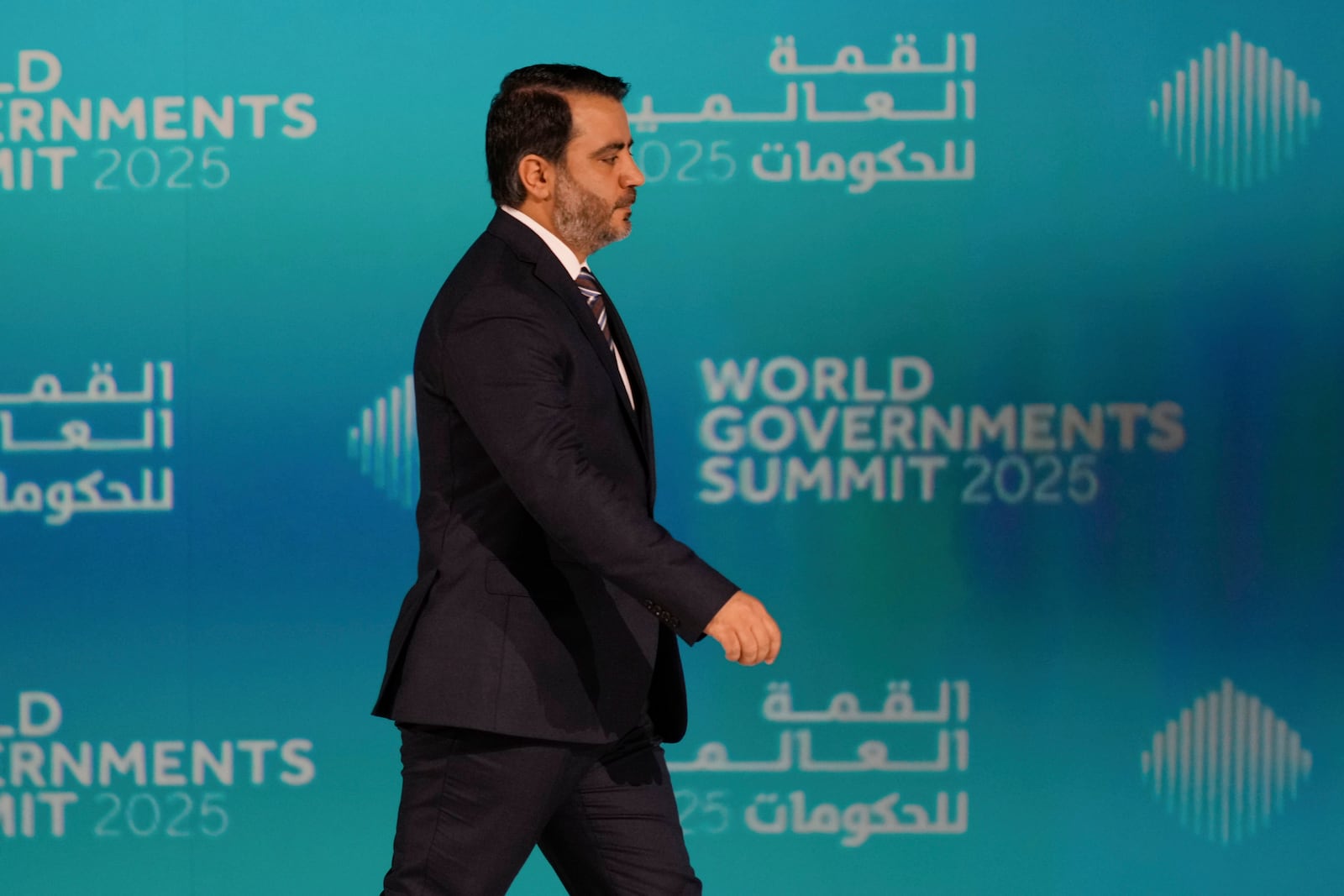 Syria's Interim Foreign Minister Asaad al-Shibani arrives on the stage for a talk with Kuwaiti journalist Ammar Taqi during the World Governments Summit in Dubai, United Arab Emirates, Wednesday, Feb. 12, 2025. (AP Photo/Altaf Qadri)