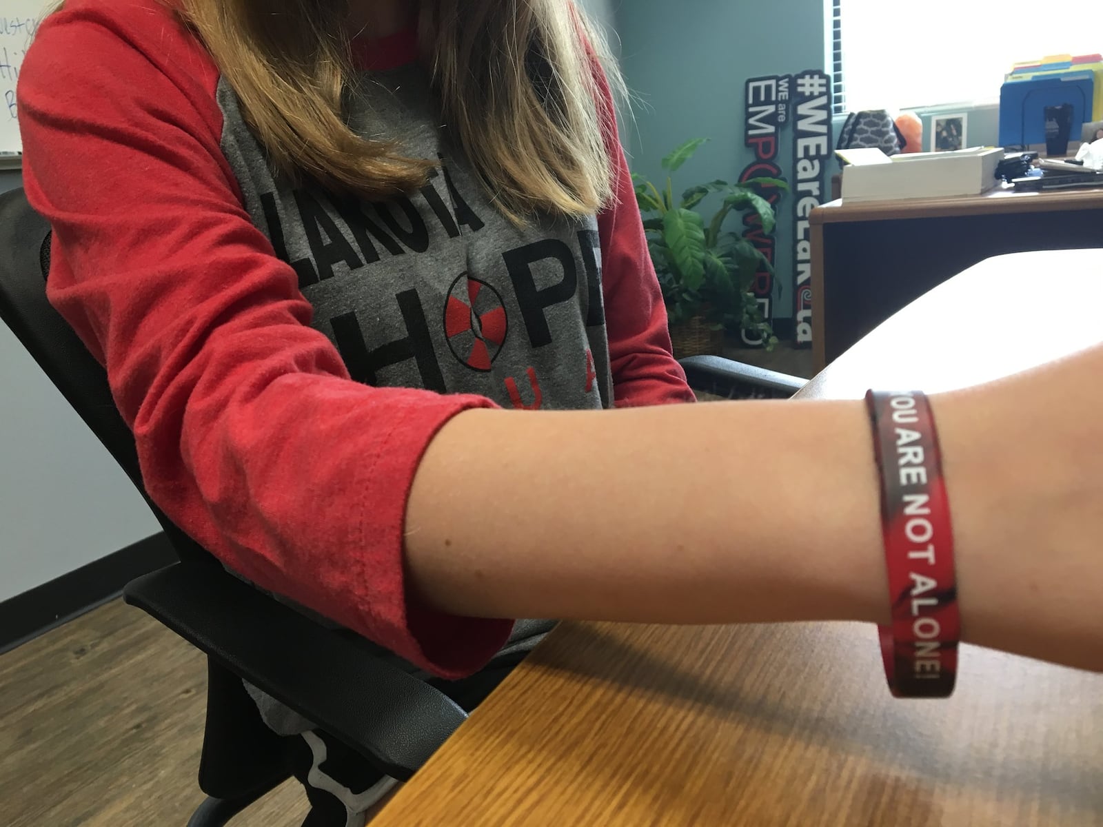 Eliana Bishop, 15, a student at Lakota West High School, shows off her Hope Squad gear. KATIE WEDELL/STAFF