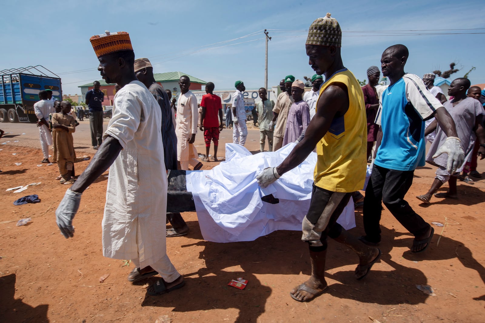 People carry the body of a victim of a tanker explosion for funeral in Majiya town, Nigeria, Wednesday, Oct. 16, 2024. (AP Photo/Sani Maikatanga)