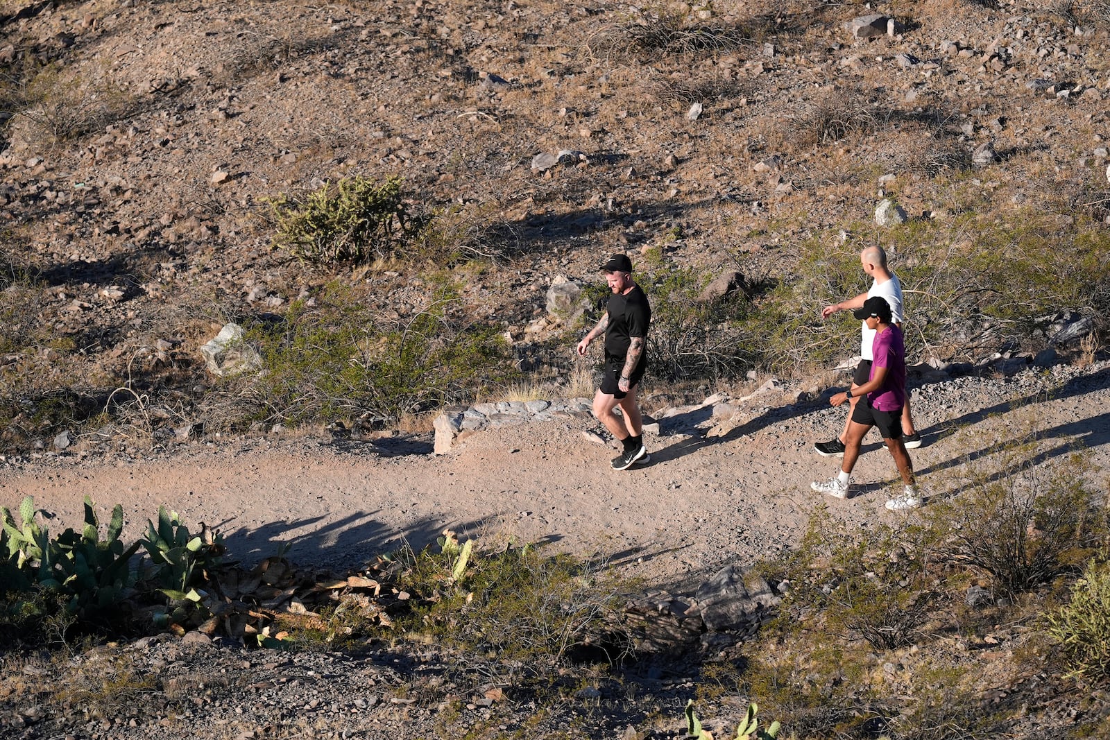 Hikers walk a trail near "A" Mountain Tuesday, Sept. 24, 2024, in Tempe, Ariz. (AP Photo/Ross D. Franklin)