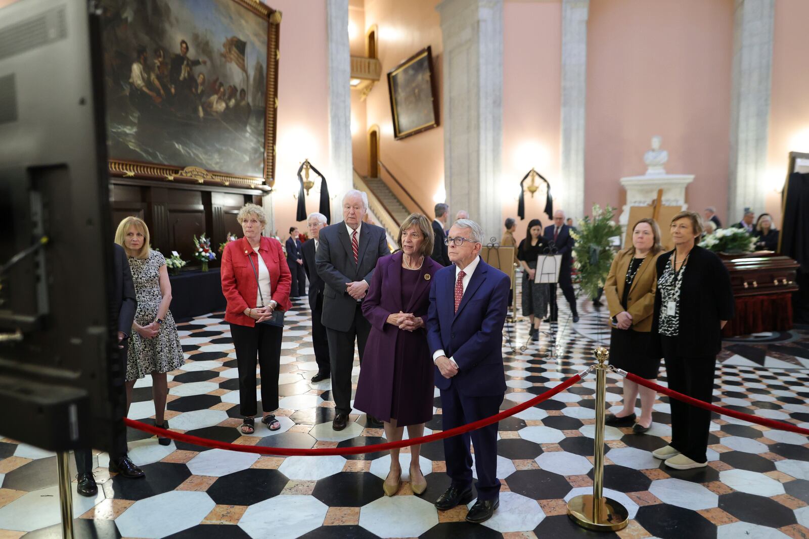 Ohio governor Mike DeWine, right, and his wife Fran watch a slide shoe honoring former Ohio House speaker Jo Ann Davidson as her casket lie in state in the rotunda of the Ohio Sate House in Columbus, Ohio, Thursday, Oct. 31, 2024. (AP Photo/Paul Vernon)