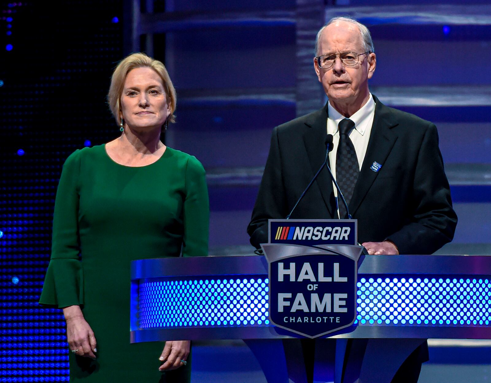 FILE - CEO and Chairman of NASCAR Jim France, right, along with the Executive Vice President of NASCAR Lesa Kennedy announce the Landmark Award to Edsel Ford II the Hall of Fame induction ceremony in Charlotte, N.C. Jan. 31, 2020. (AP Photo/Mike McCarn, File)